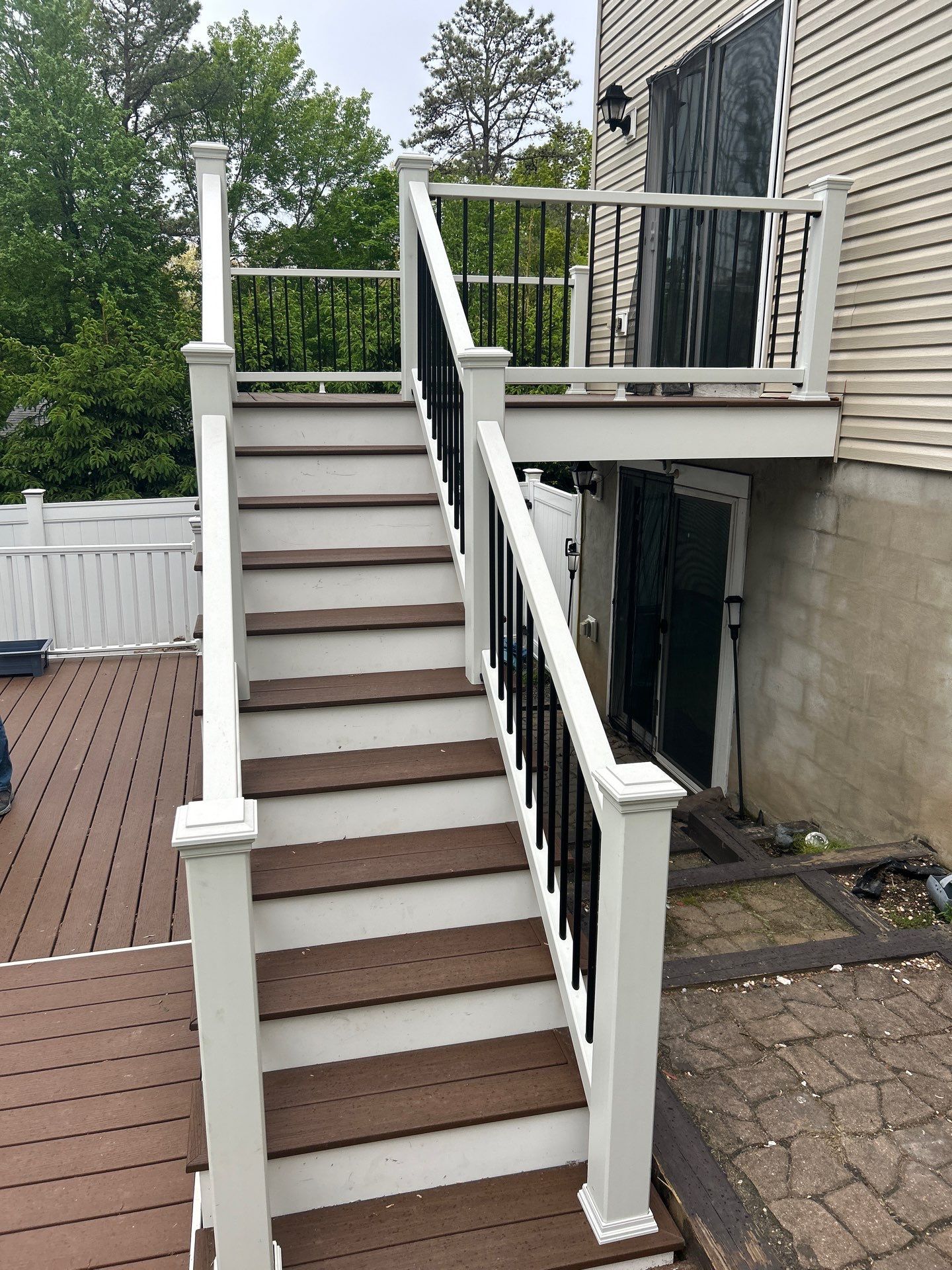 Elevated Composite Deck Replacement with White Railing in Tannersville by Herts Roofing & Construction
