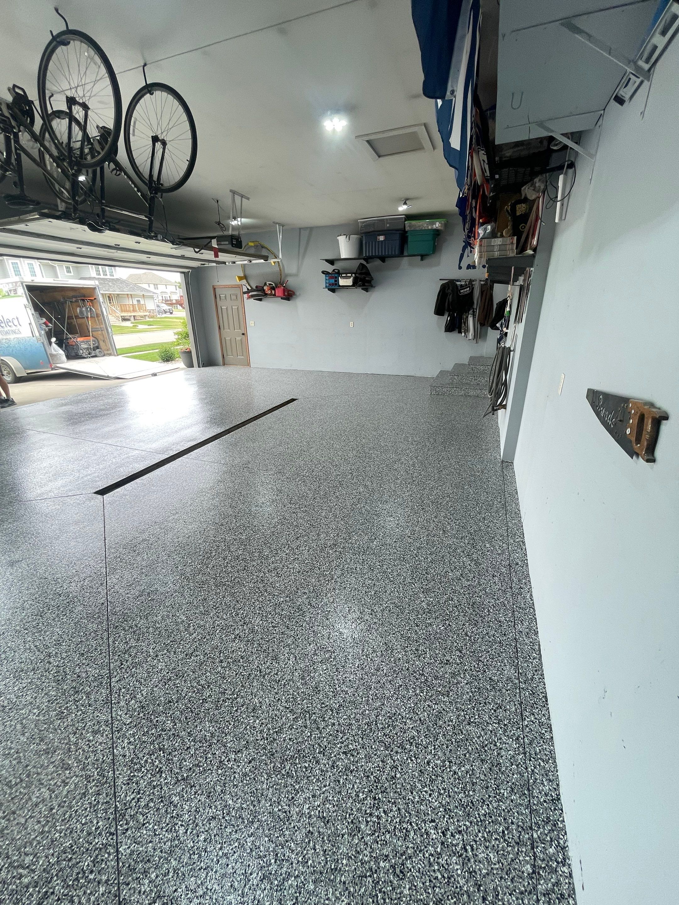 Full Garage Floor Epoxy Coating Installation in Dell Rapids by Select Painting, Coatings & Garage Cabinets