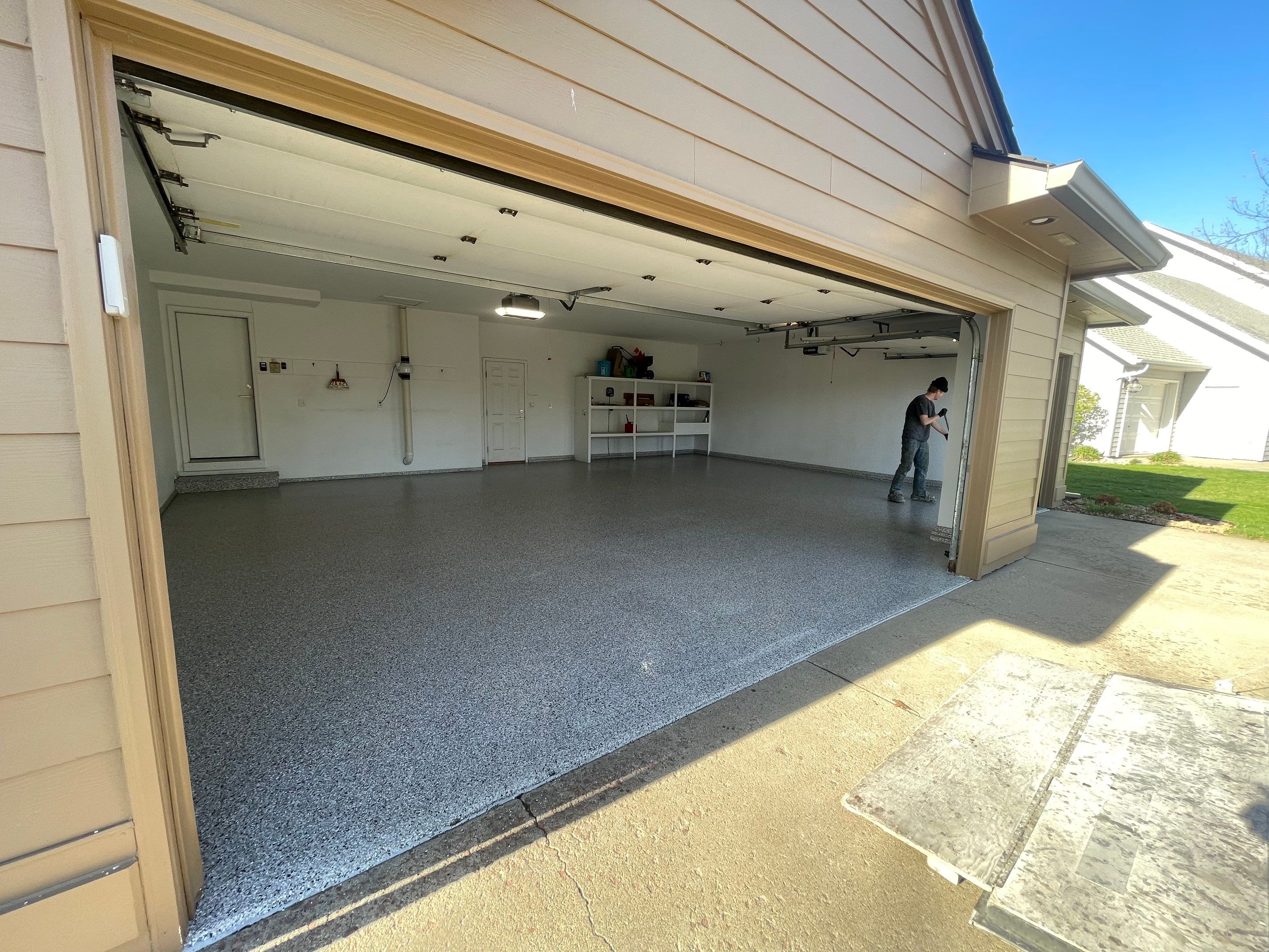 Yankton Garage Floor Restoration with Gray Speckled Epoxy Coating by Select Painting, Coatings & Garage Cabinets