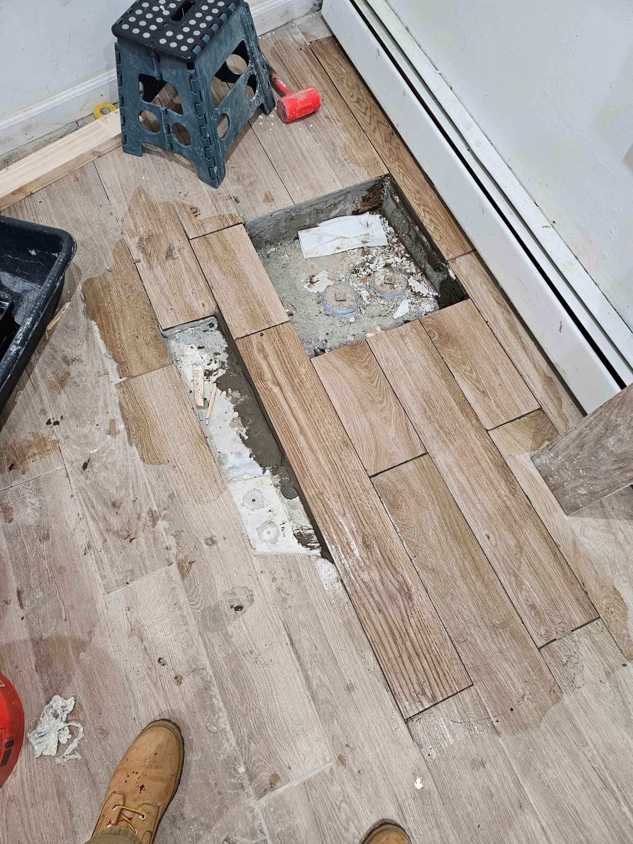 The replacement of a crumbing leaky house u-trap in basement by WG's Remodeling Inc