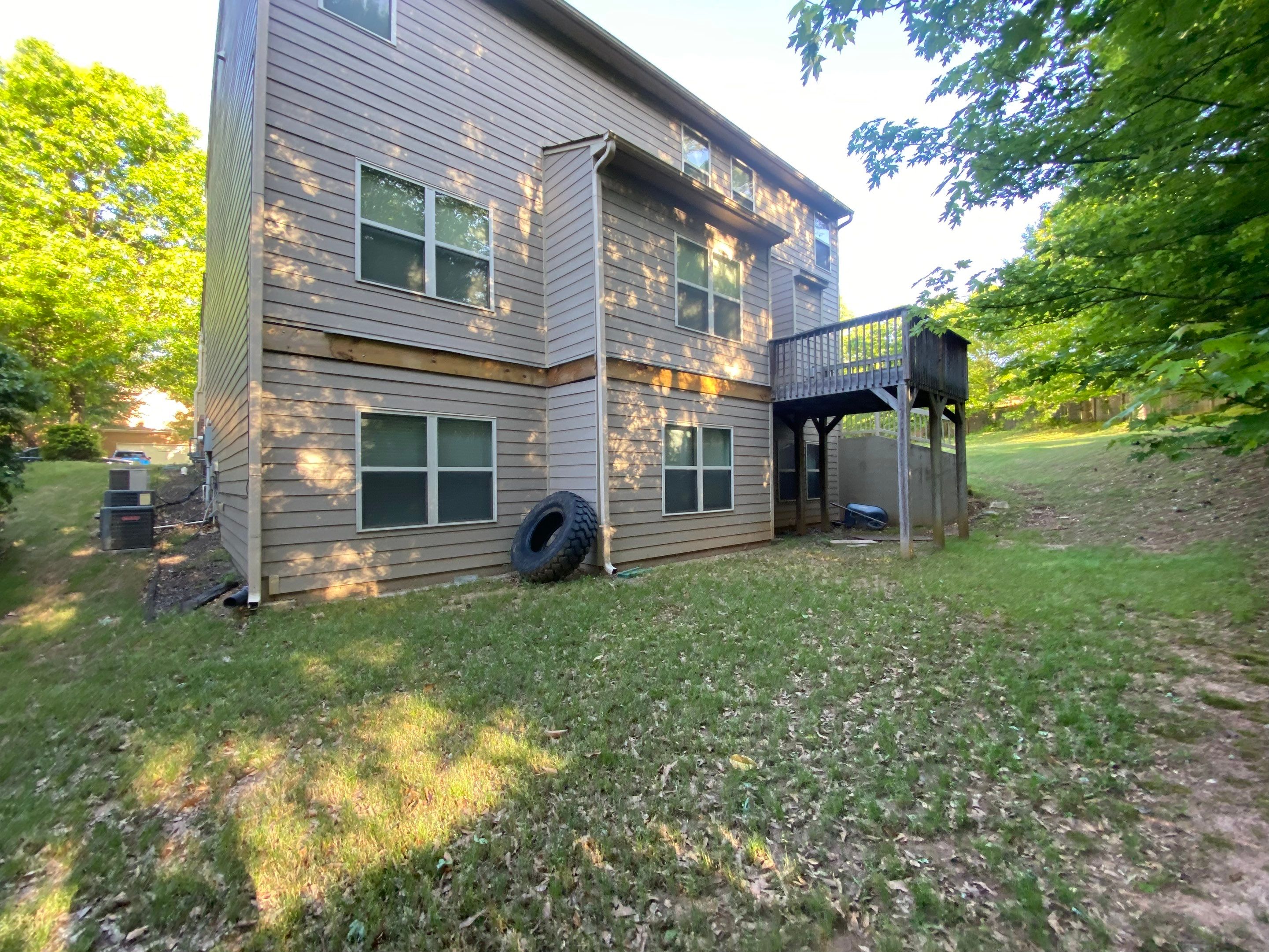 Custom Elevated Deck Replacement with White and Black Railings by Swift Home Renovations