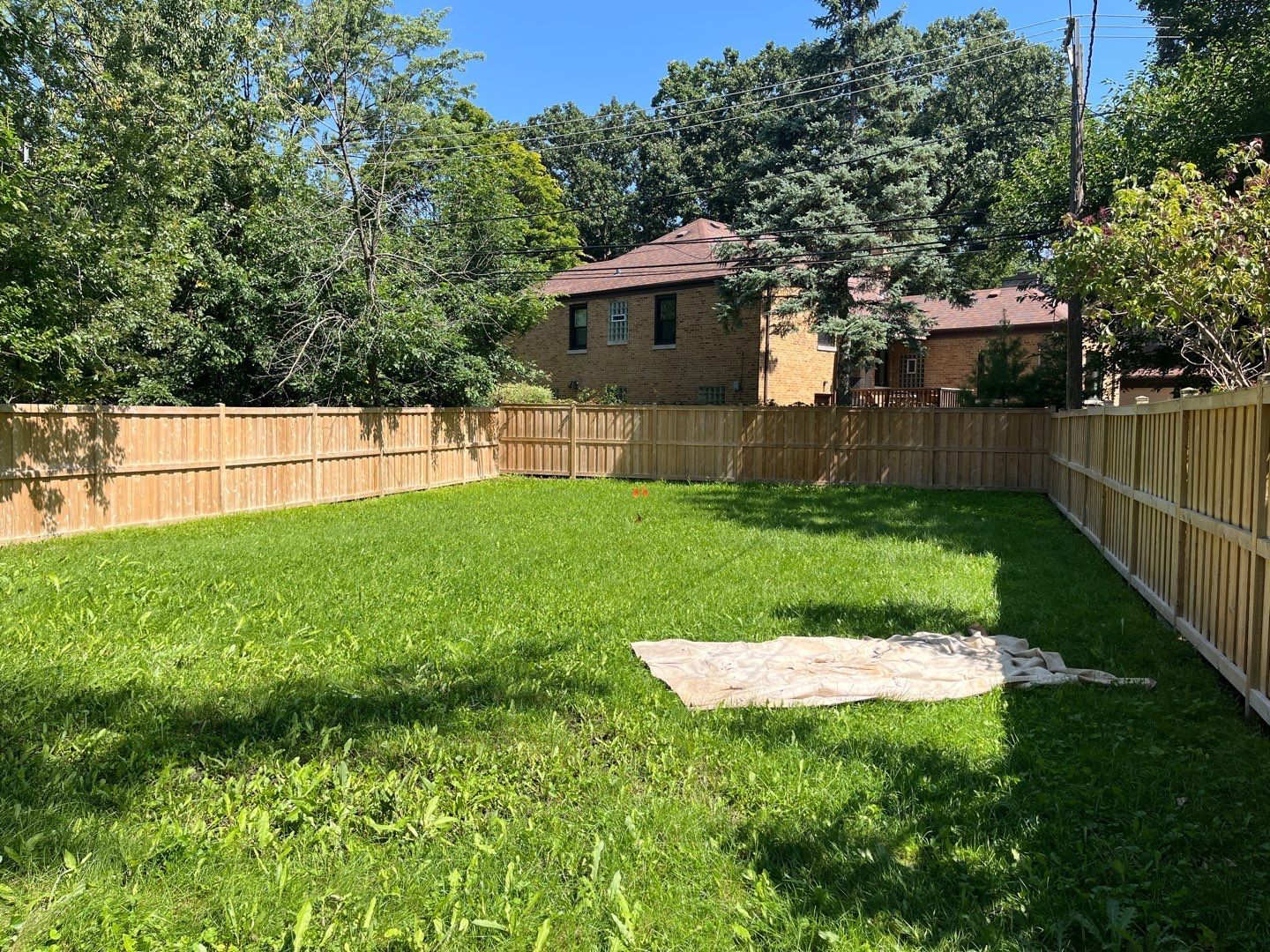Wood fence cleaning and sealing by Northern Power Washing LLC.
