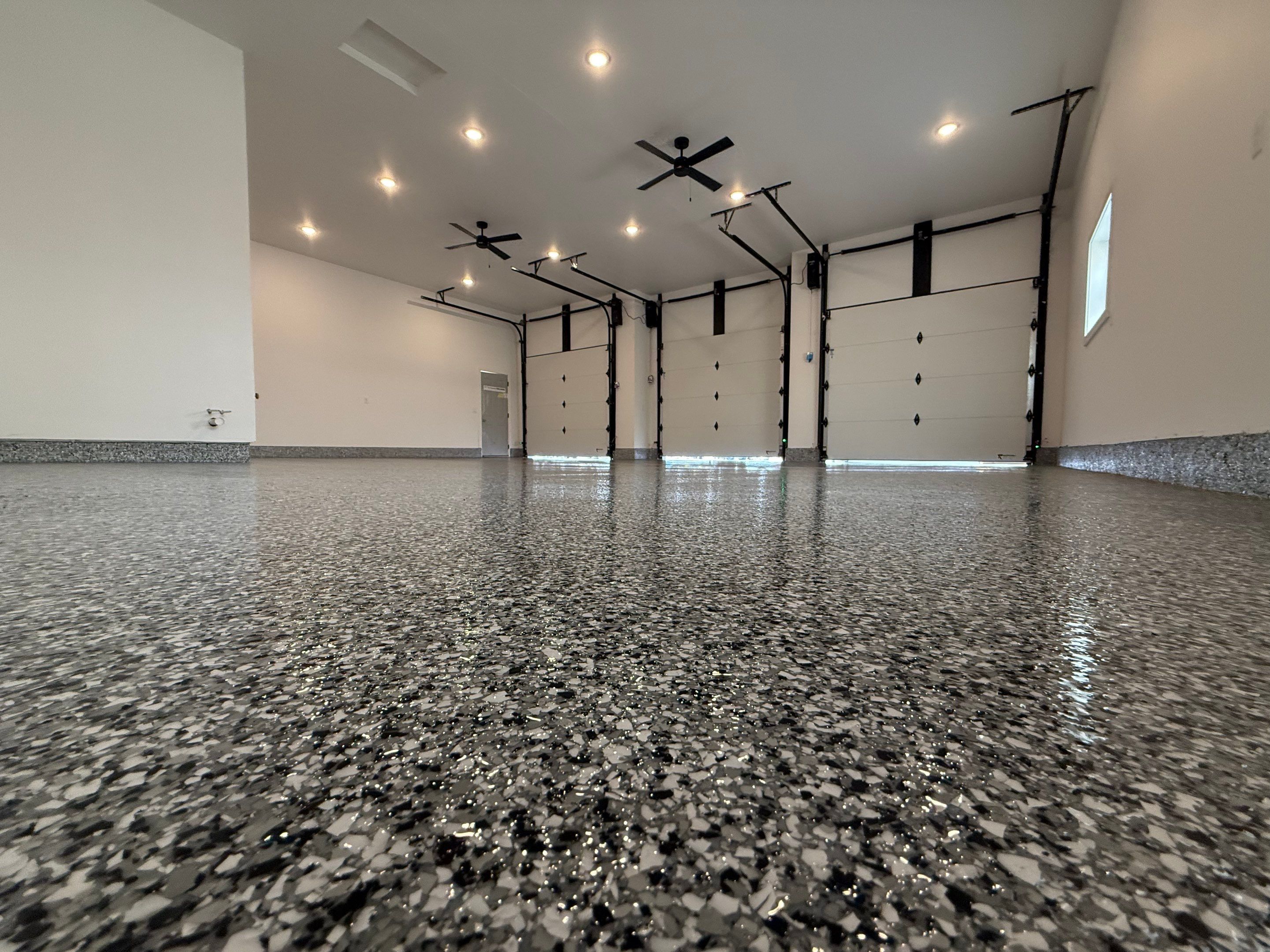 Multi-Car Garage Epoxy Floor Coating and Concrete Finishing in Sioux Falls by Select Painting, Coatings & Garage Cabinets