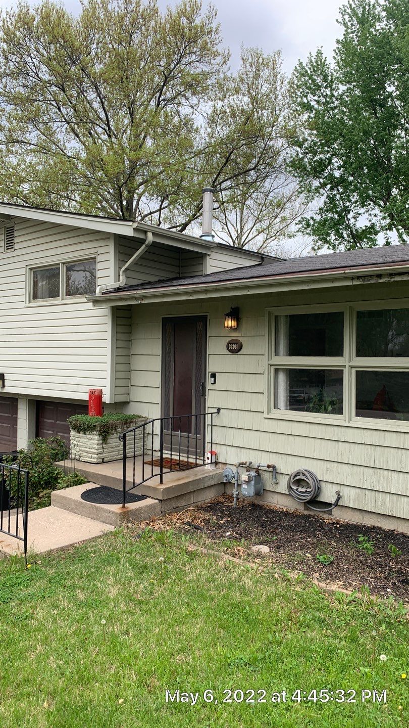 White Craneboard Siding and Heartland Window Installation in Parkville by EEC Windows, Siding & Roofing