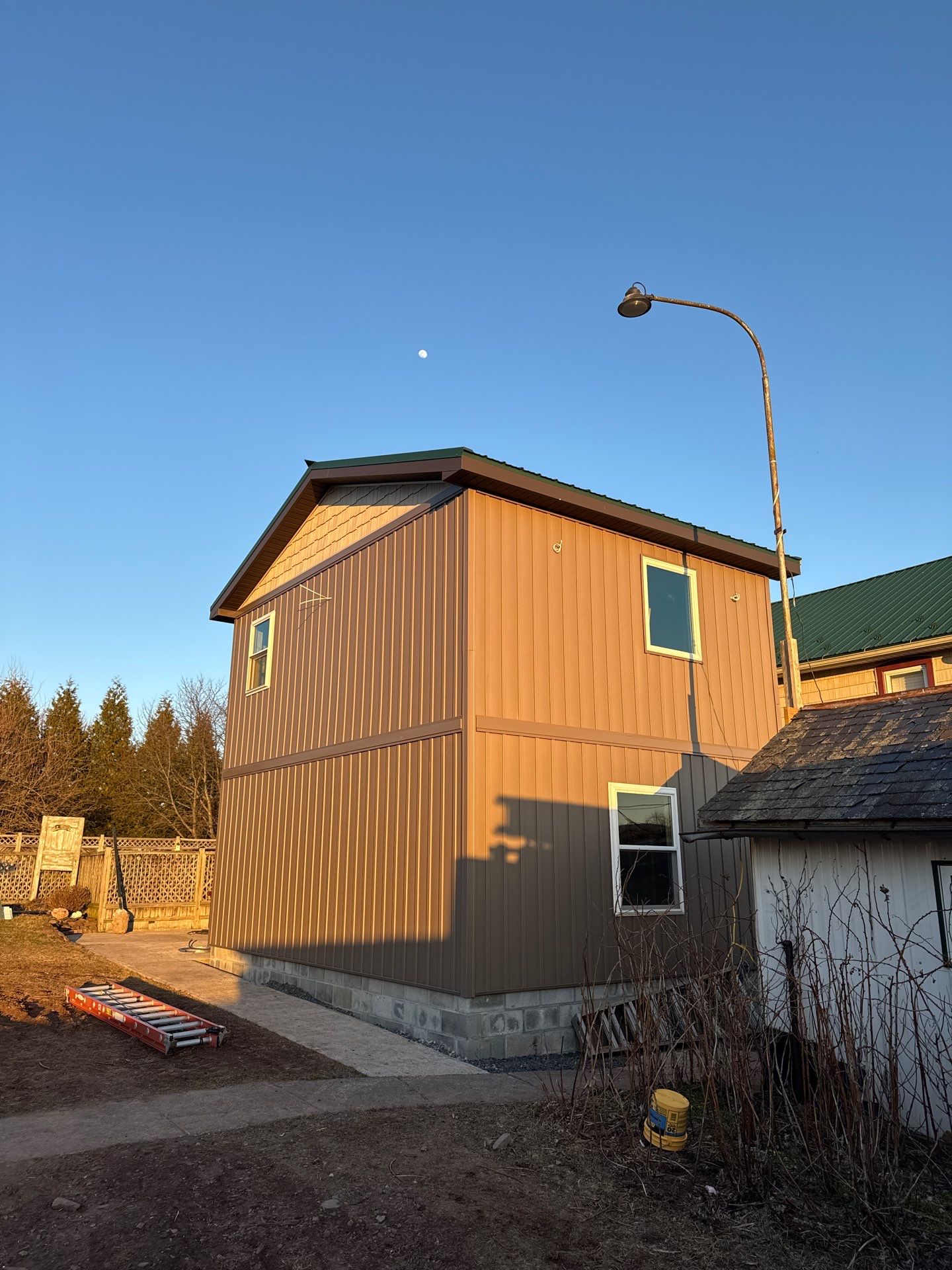 Multi-Story Residential Addition Featuring Textured Metal Siding in Millersburg by Esh Builders