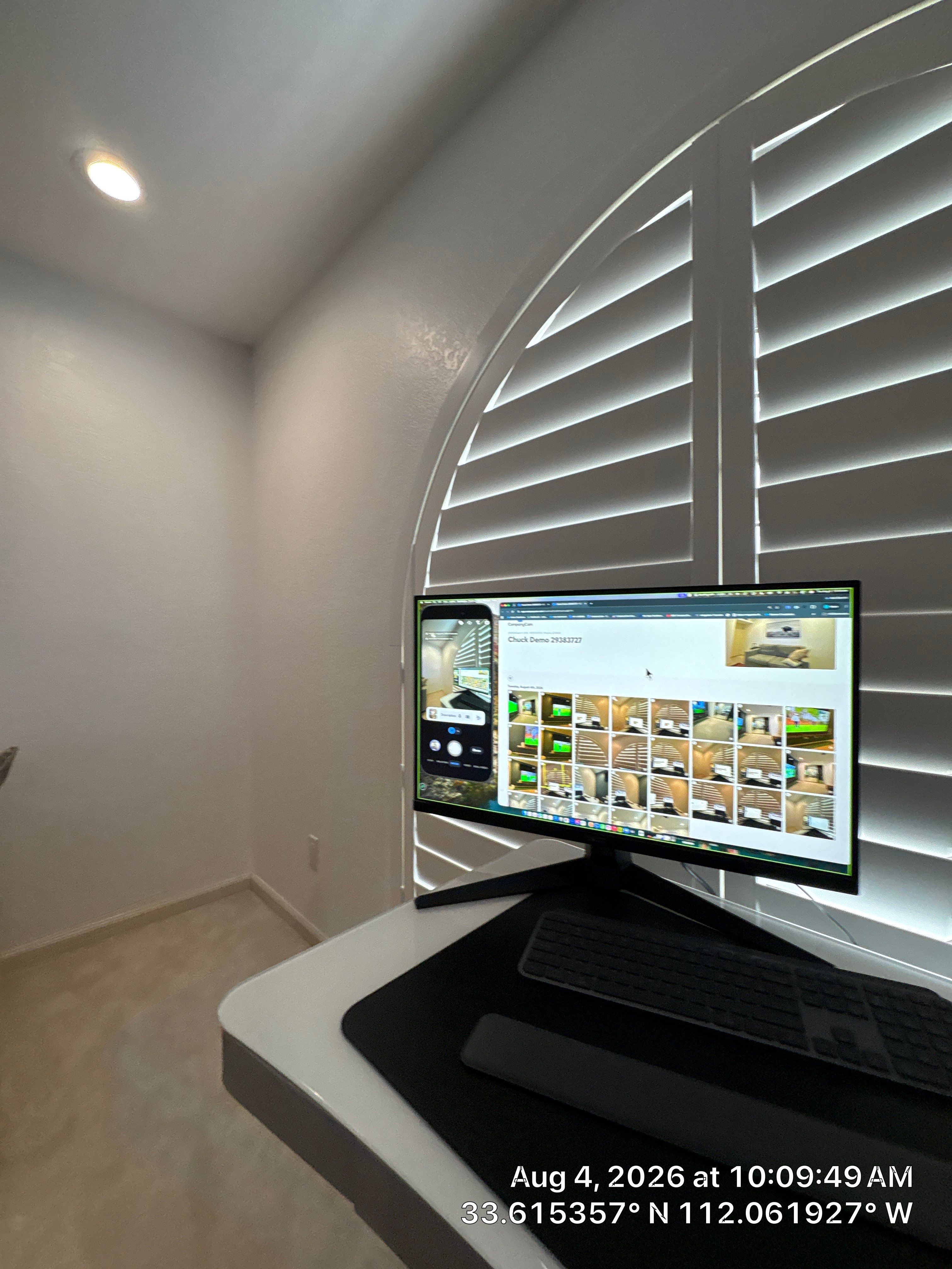 Custom Home Office Setup Featuring Arched Plantation Shutters and Accent Wall by CompanyCam Sales Demo