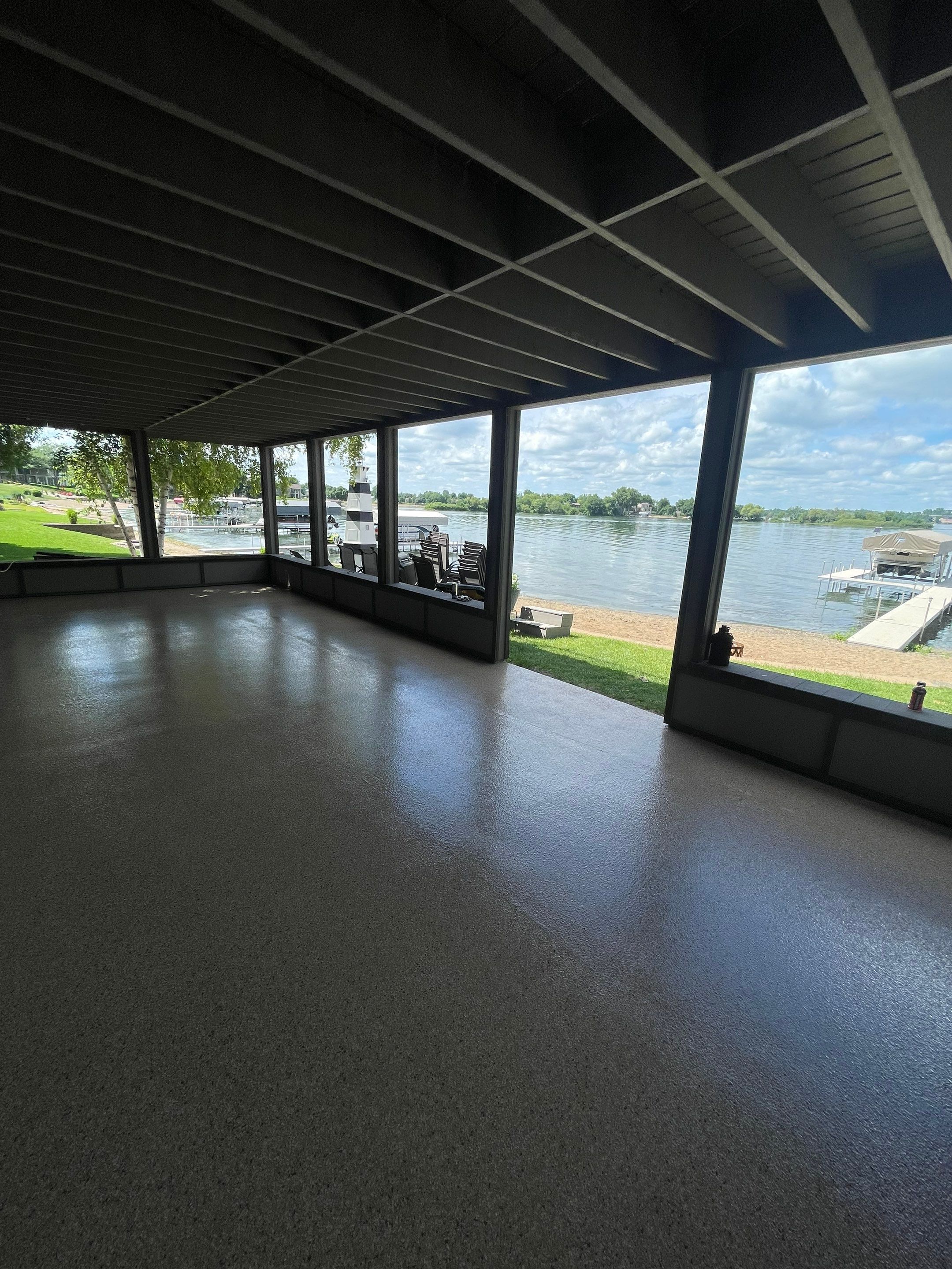 Lakefront Screened Patio Concrete Coating Installation in Wentworth by Select Painting, Coatings & Garage Cabinets