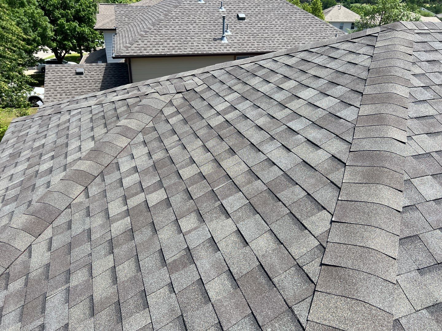 Wind damaged roof replacement by Oakwood Roofing and Construction, LLC