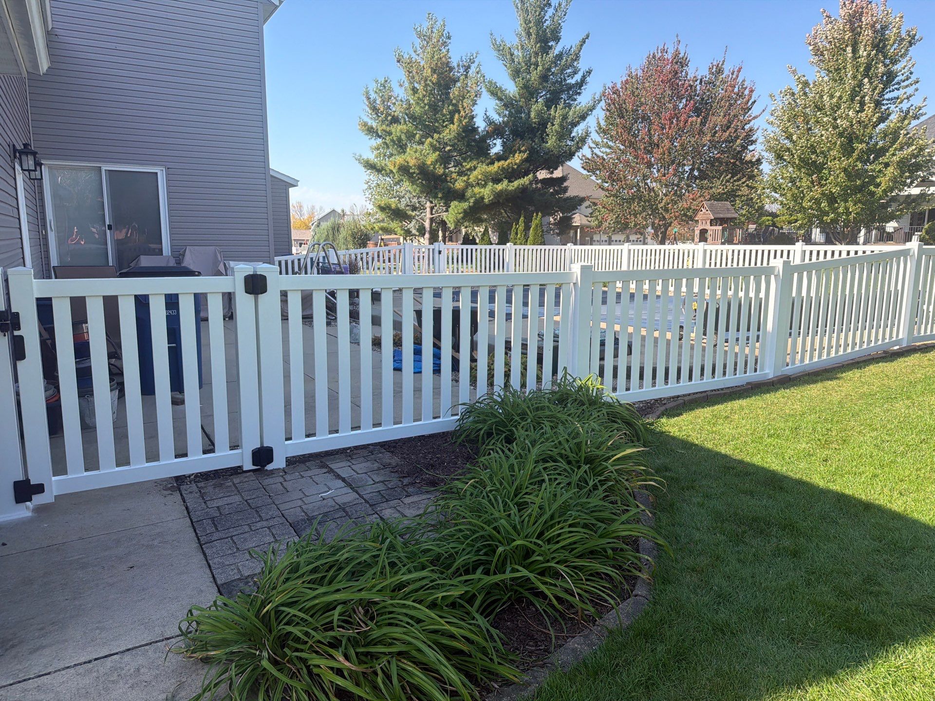 White Vinyl Picket Pool Fence Installation in Waterloo, Iowa by Perfect Picket Fence and Stain