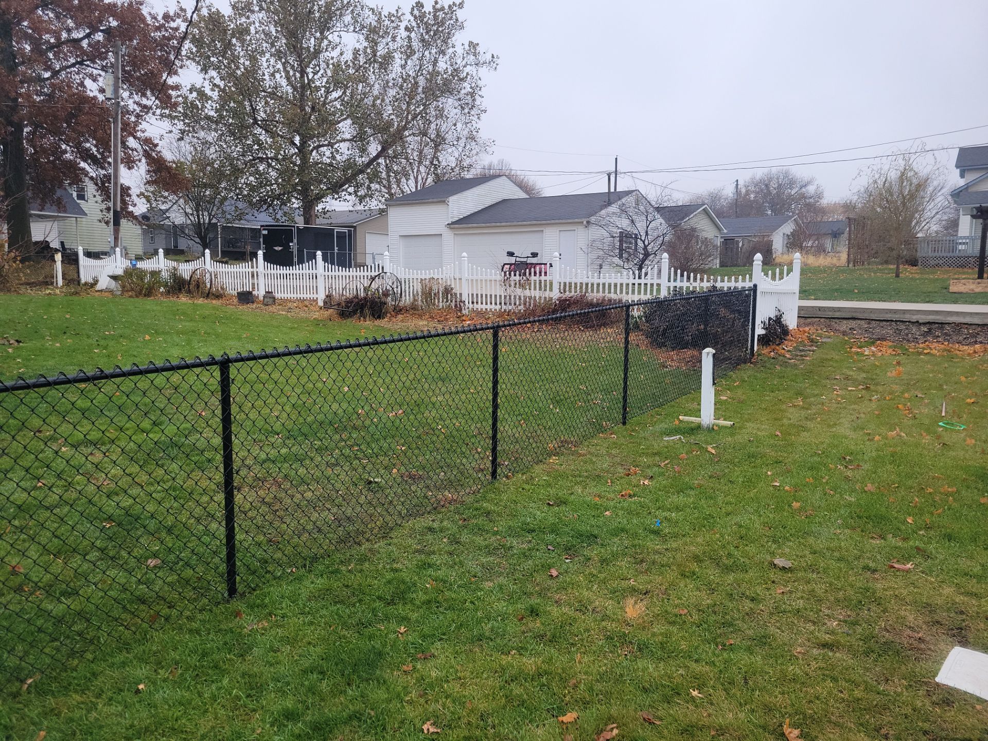 Black Vinyl-Coated Chain Link Fence Installation in Aplington by Perfect Picket Fence and Stain