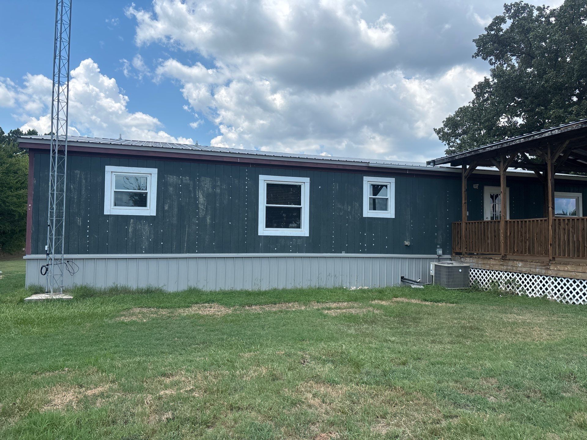 Exterior Painting in Fruitvale, TX | Wood Porch & Home in Deep Navy Blue by Quality Coats Painting