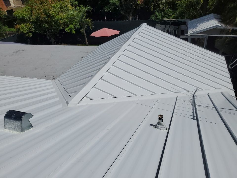 Residential Roofing Installation using 1.5" Nail Strip 24ga Solar White Kynar Coated Standing Seam Metal Panels by Morton Roofing, Inc.
