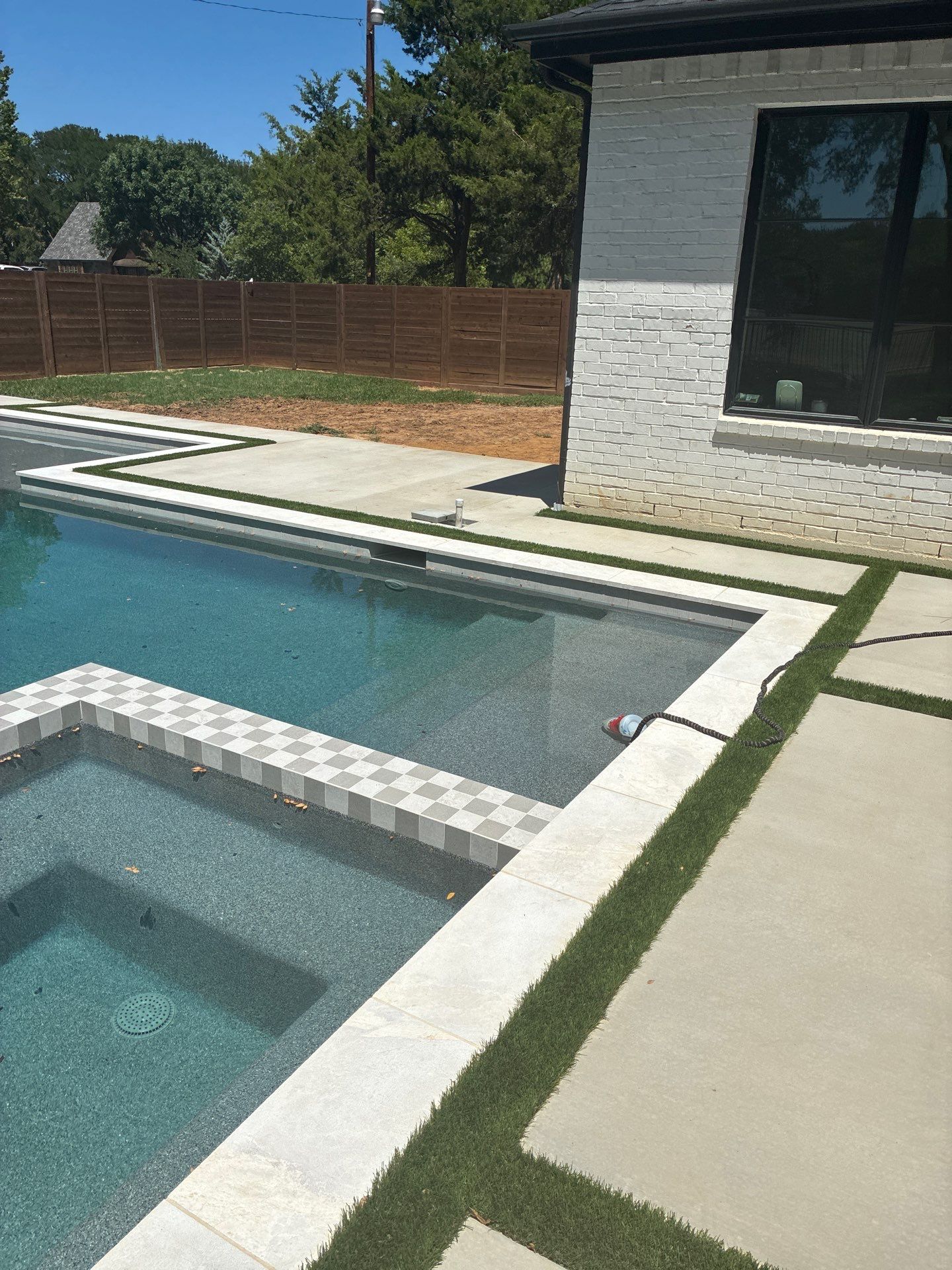 Modern Geometric Pool with Integrated Spa and Turf-Inlaid Decking by Pinnacle Pools and Spas - DFW