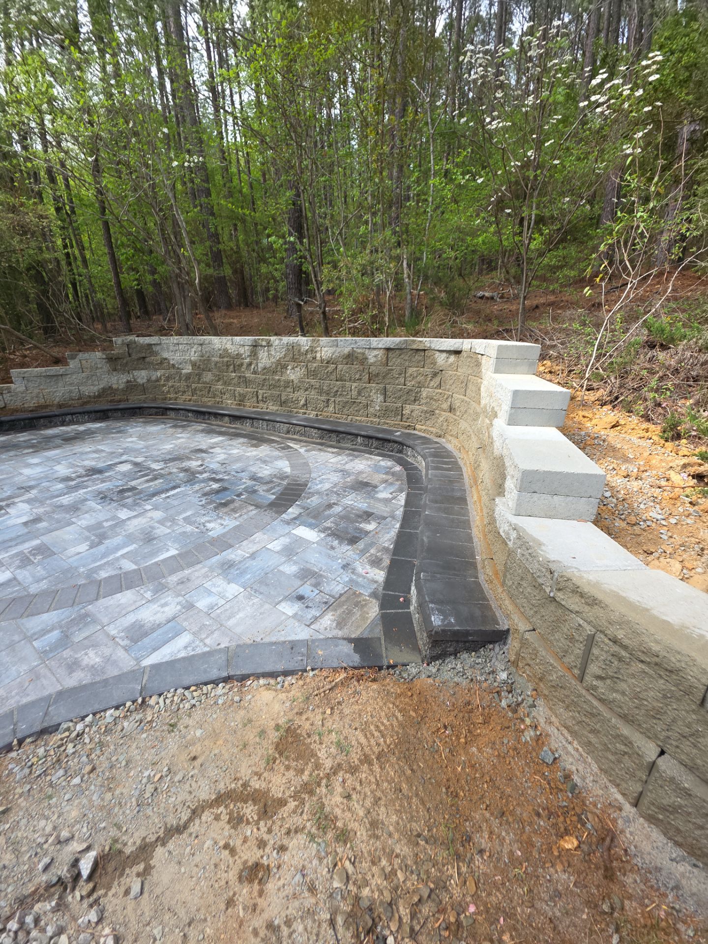 Pittsboro Outdoor Living Transformation – Retaining Wall, Paver Patio & Elevated Deck by Elite Remodeling and Design LLC