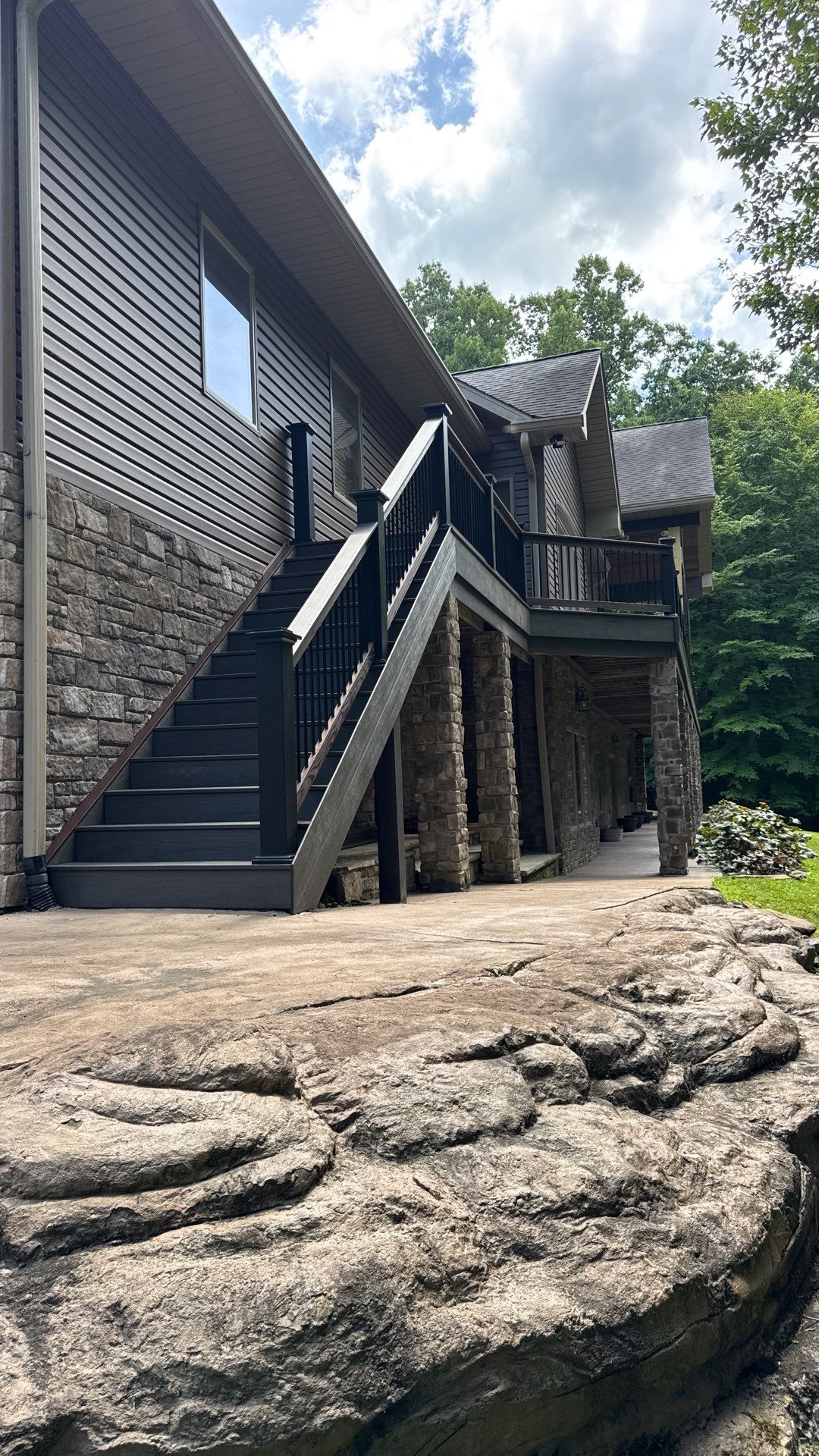 Custom Composite Deck Construction with Stone Pillars in Fayetteville by Walnut Hollow Decks & Outdoor Living