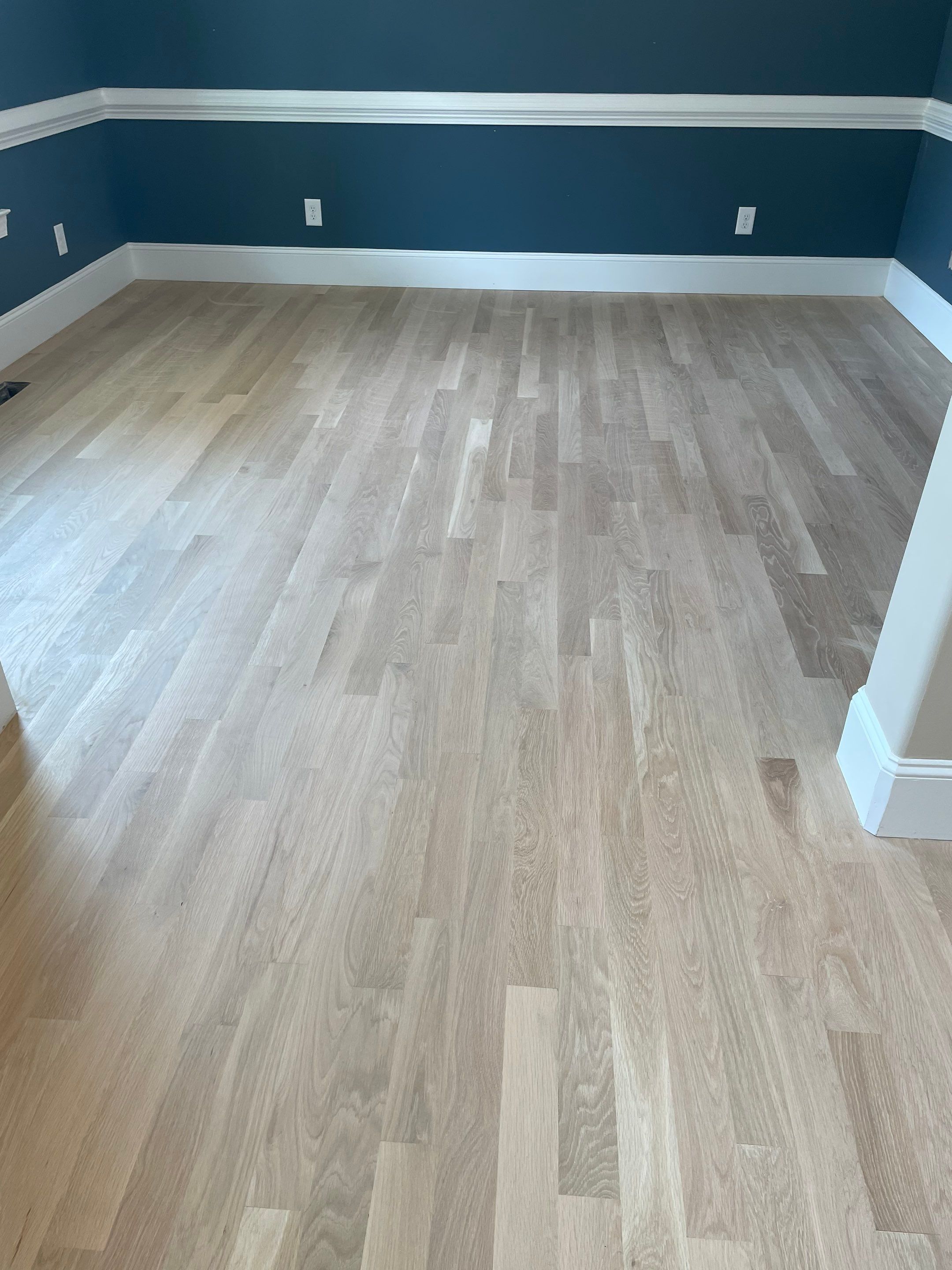 New white oak floors, stained a red tone. by Accent Custom Floors