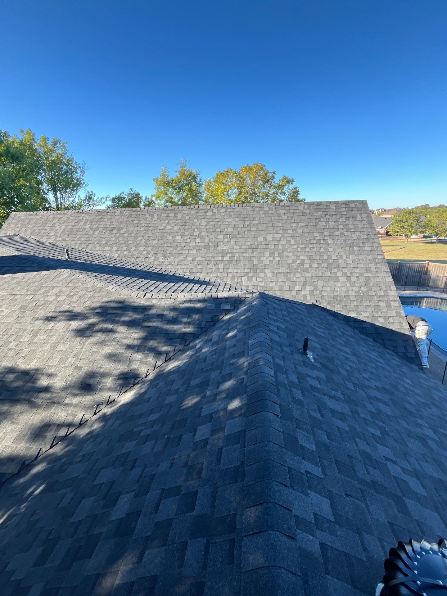 White brick with IKO Granite Black by Tejas Roofworks + Restoration
