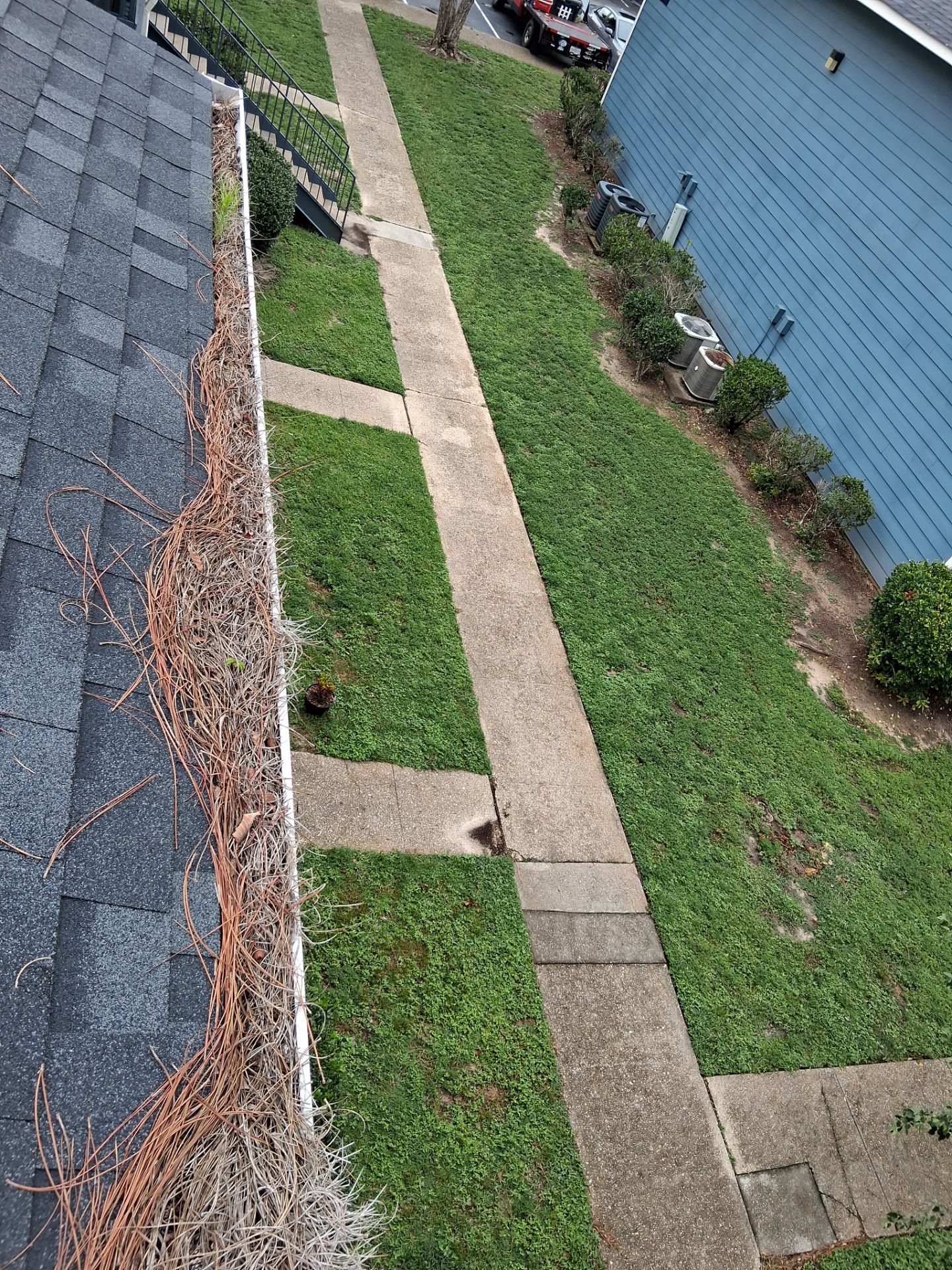 Commercial gutter cleaning Gulfport & Biloxi, MS before photo with filled gutters