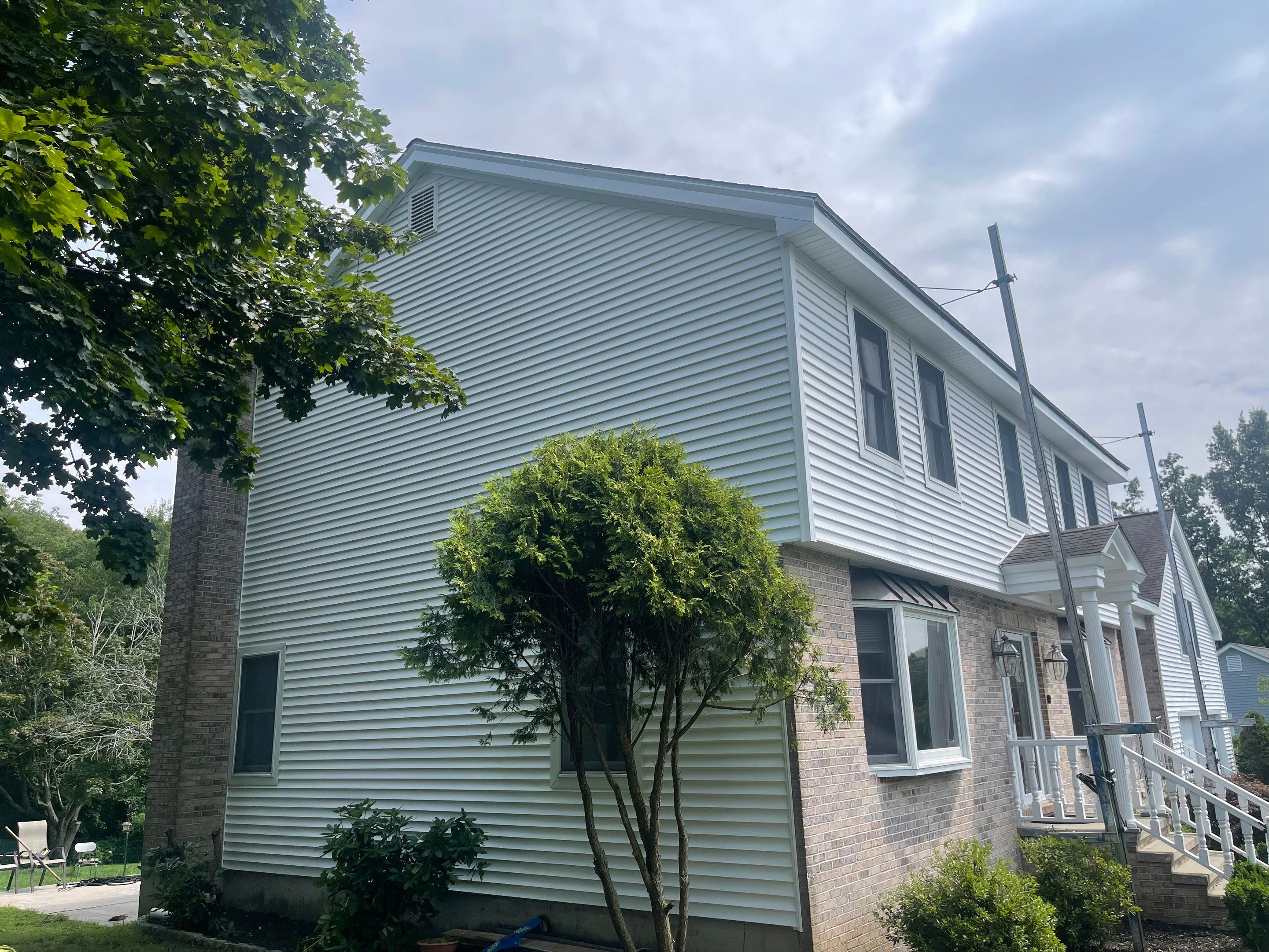 Siding Installation using Mainstreet Colonial & White gutters by A Plus Exterior