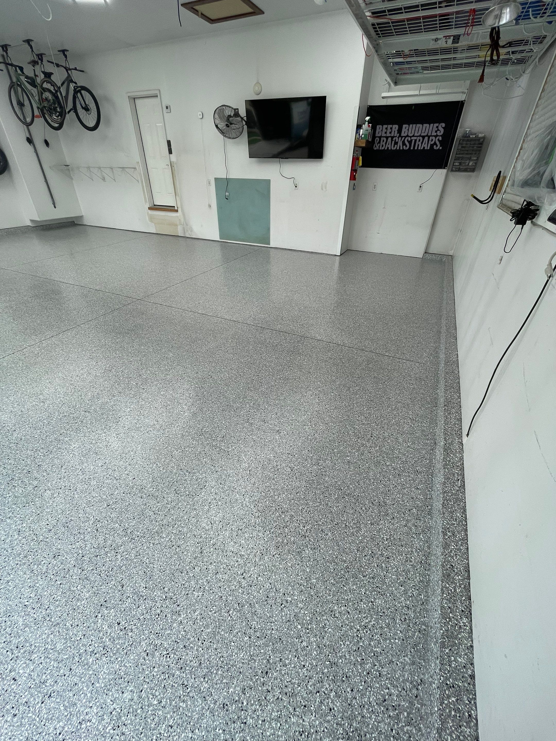 Feather Gray Epoxy Floor Coating Installation in Sioux Falls by Select Painting, Coatings & Garage Cabinets