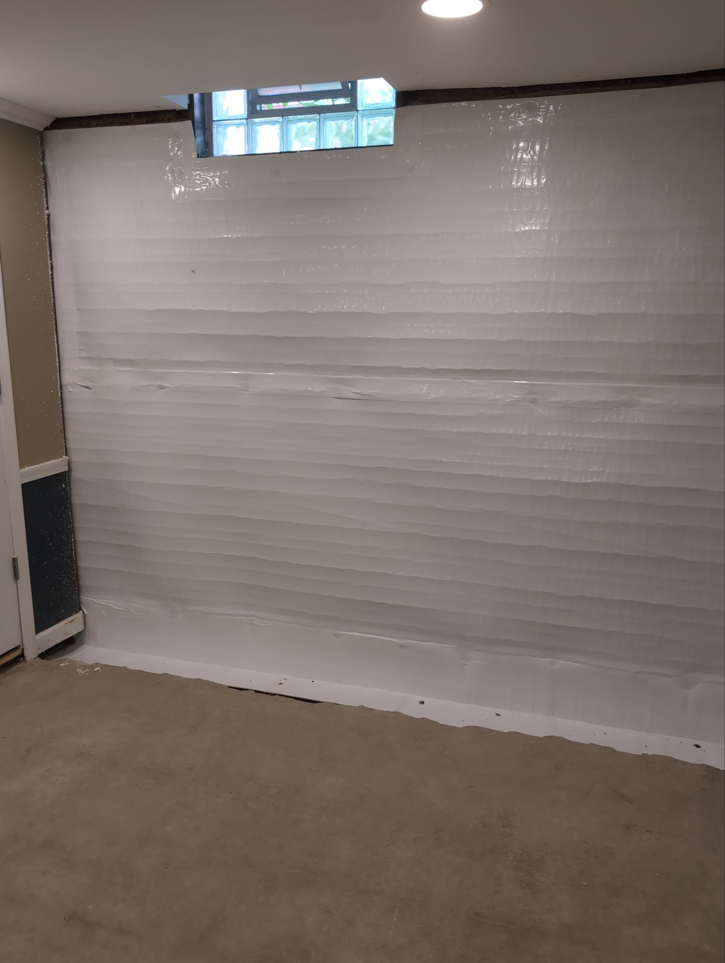 Interior Basement Waterproofing System and Egress Window Installation by Toledo Basement Repair 