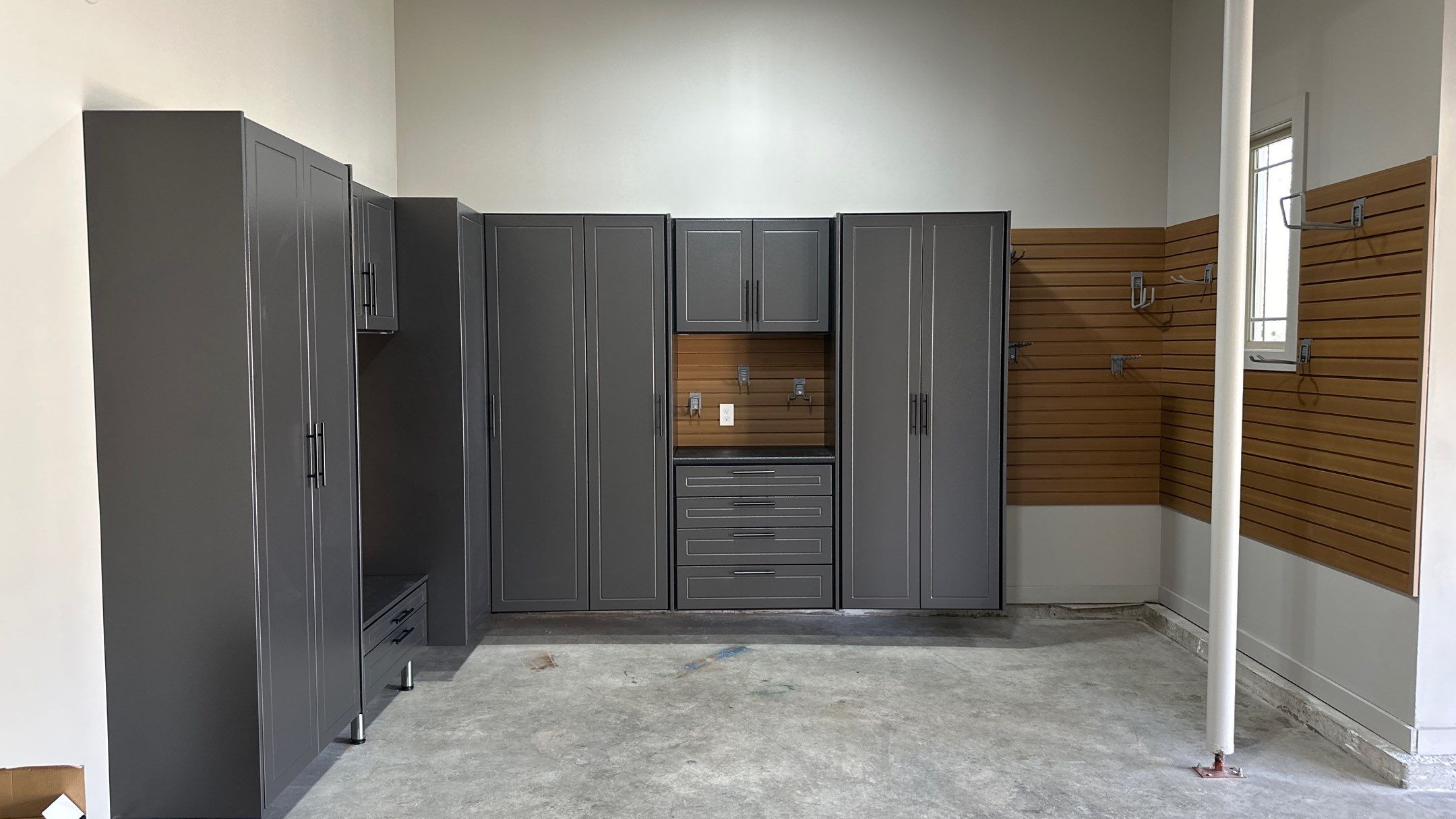 Mark S. chose Global Pine slotwall with his Pewter cabinets.  by Banner Garage