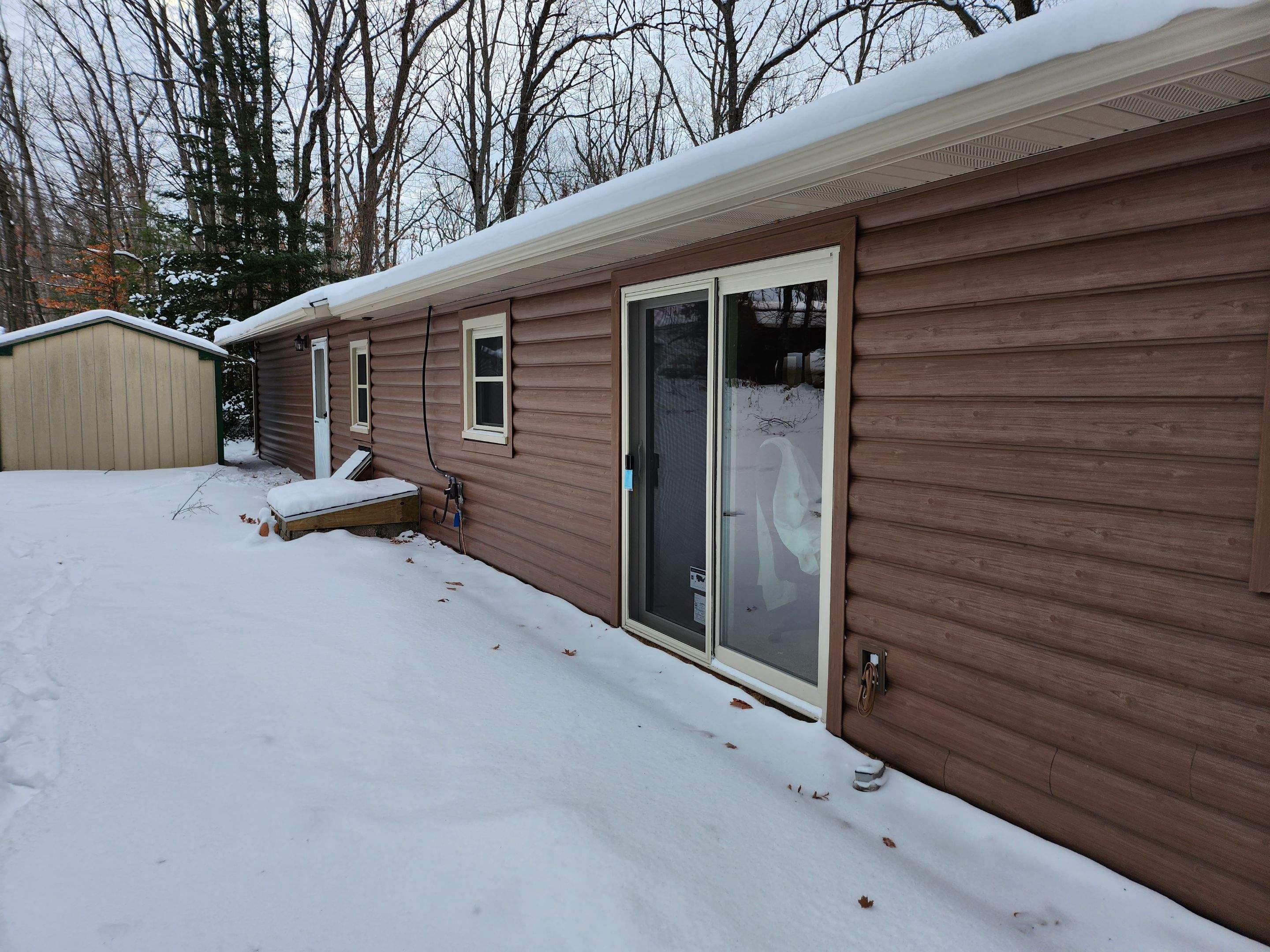 New addition and log siding by Energy Plus Home Improvements
