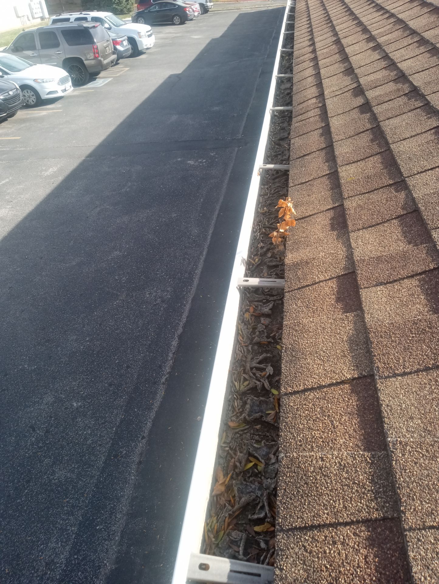 Commercial gutter cleaning Lincoln, NE before photo with filled gutters