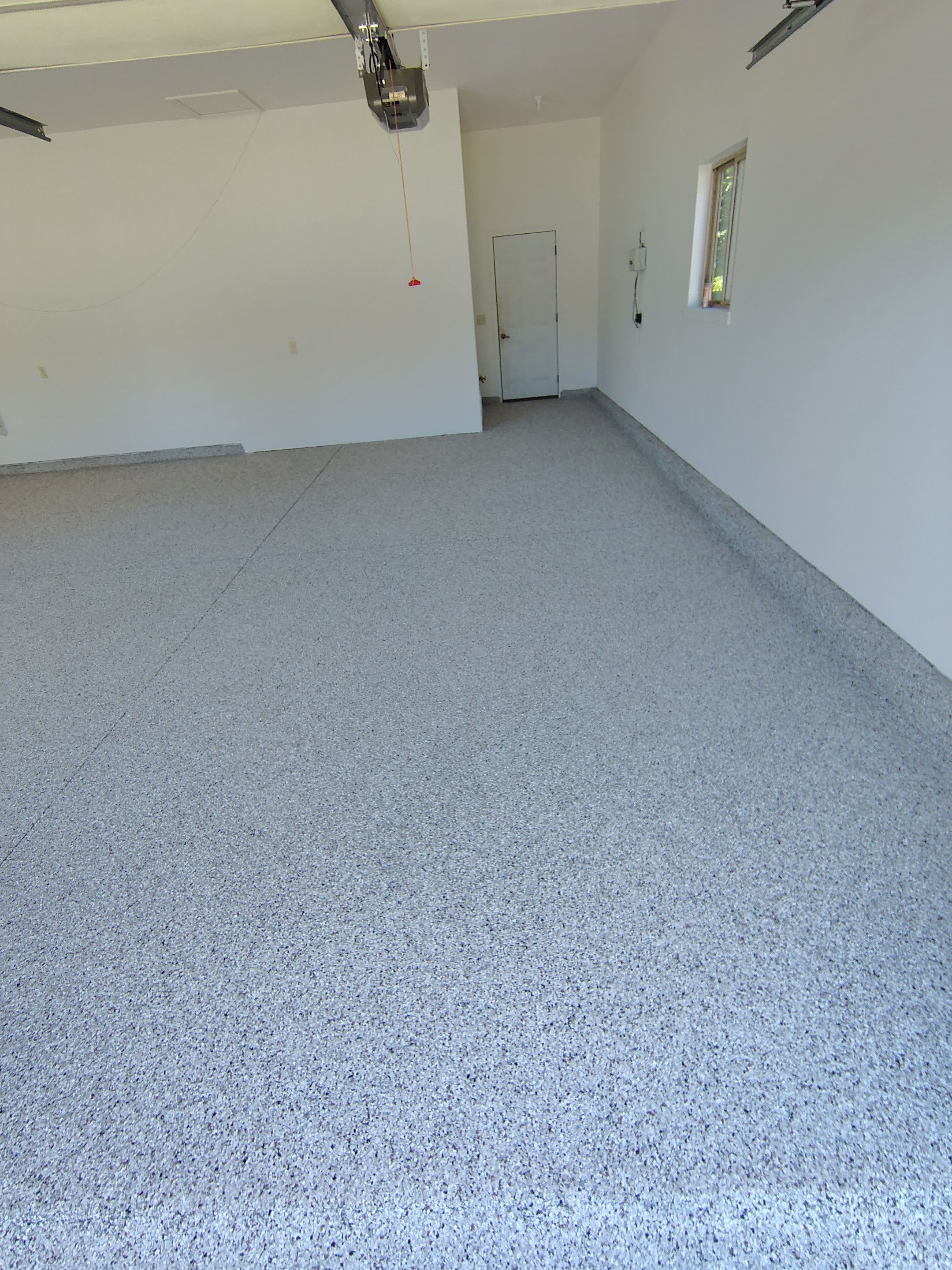Custom Grey Speckled Epoxy Floor Coating for Sioux Falls Garage by Select Painting, Coatings & Garage Cabinets