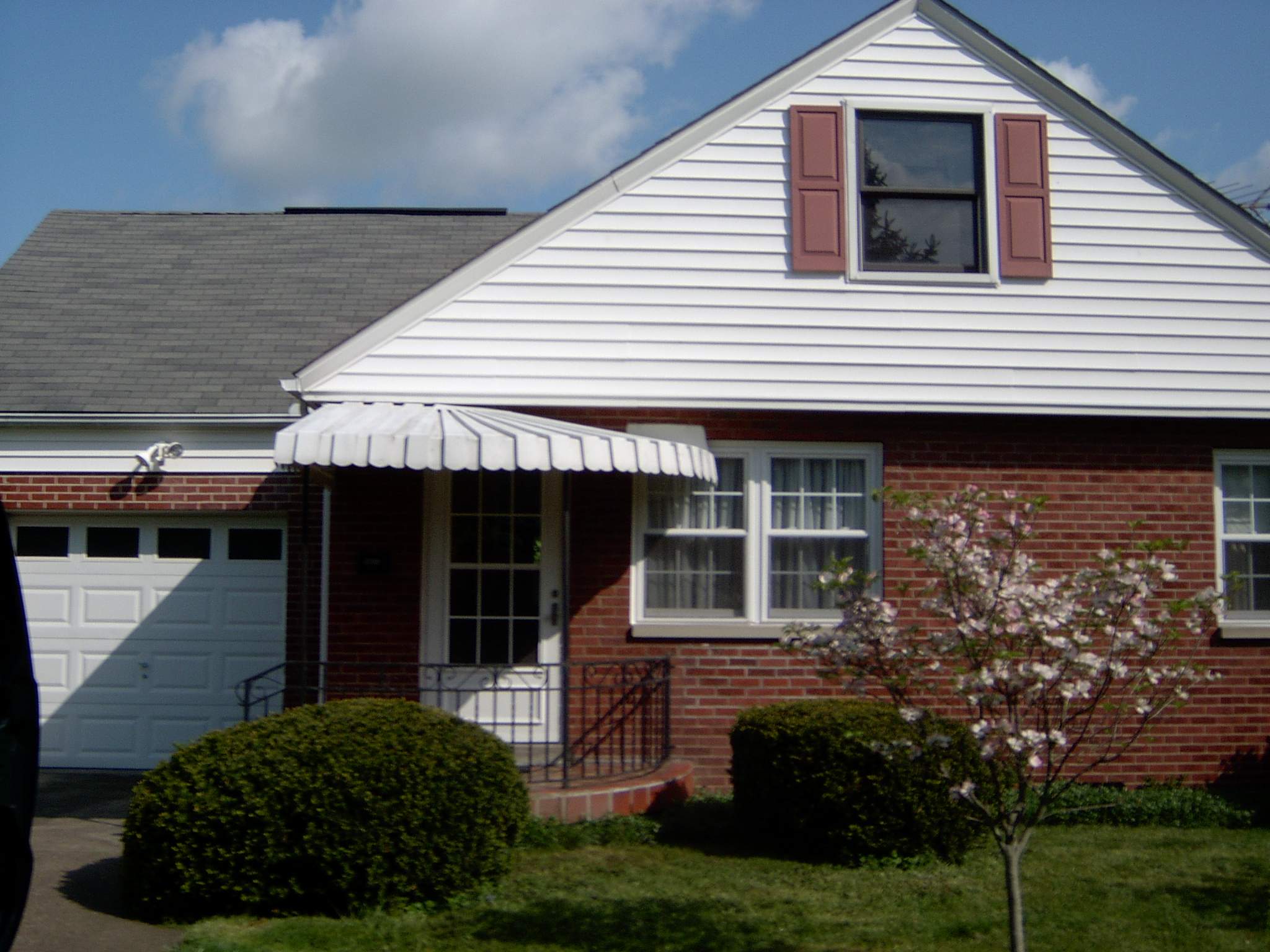 New front porch build, with tile floor and vinyl railing. by Secure Construction Company Inc