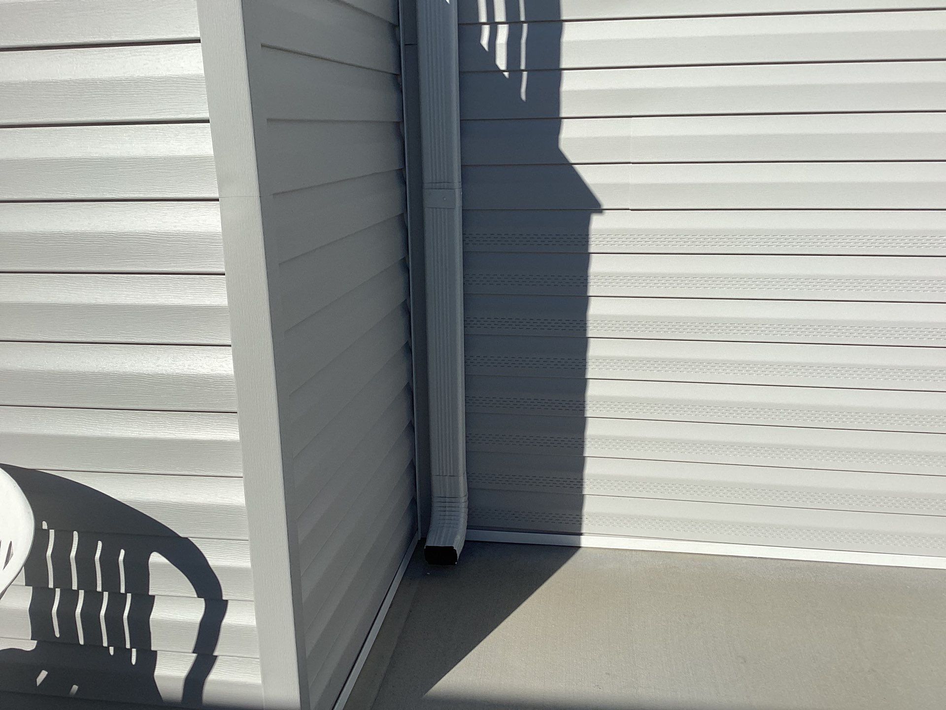 White Downspouts Installation in St. James City by Gutter Professors