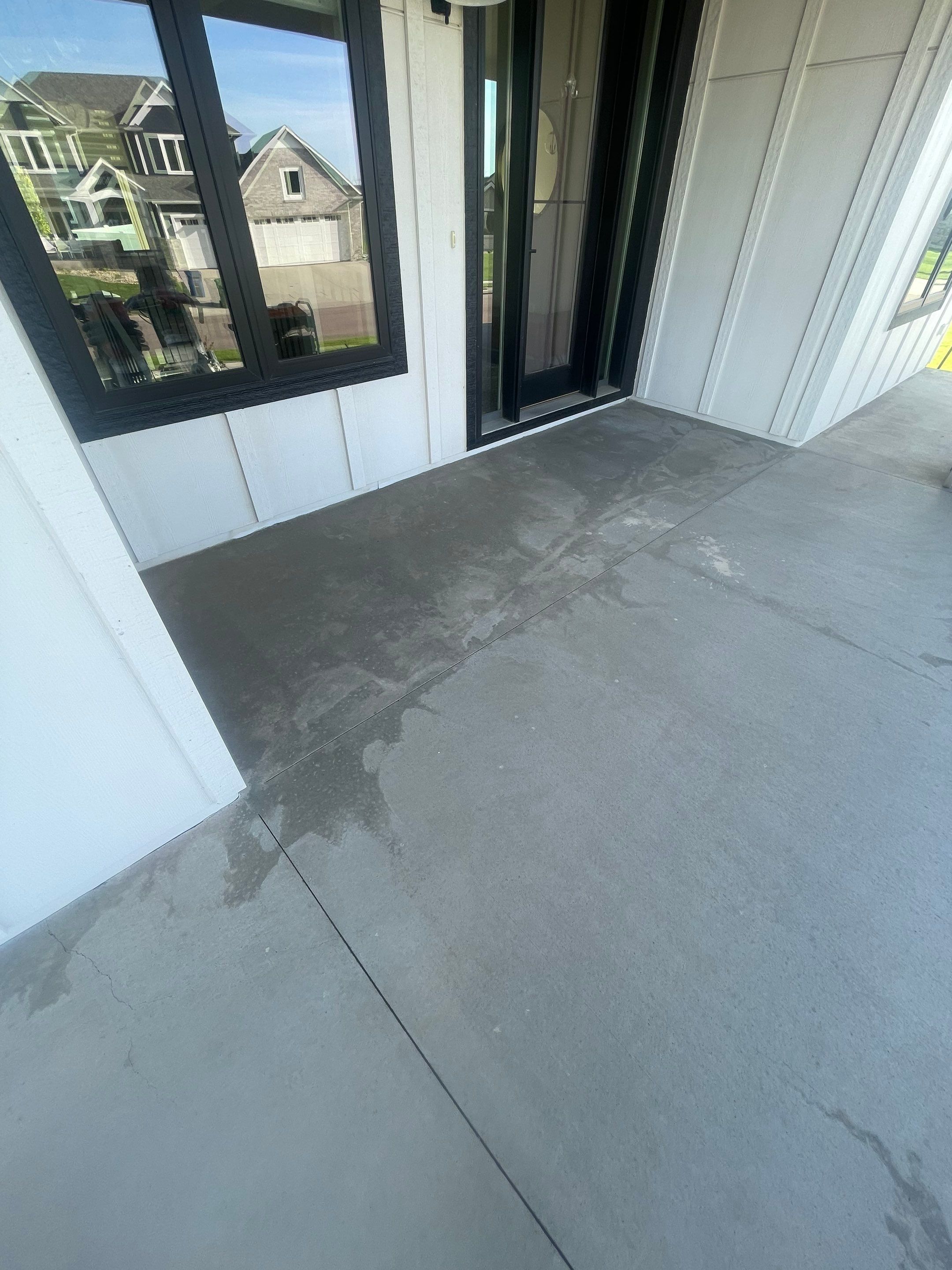 Grey Speckled Concrete Porch Coating for Sioux Falls Home by Select Painting, Coatings & Garage Cabinets
