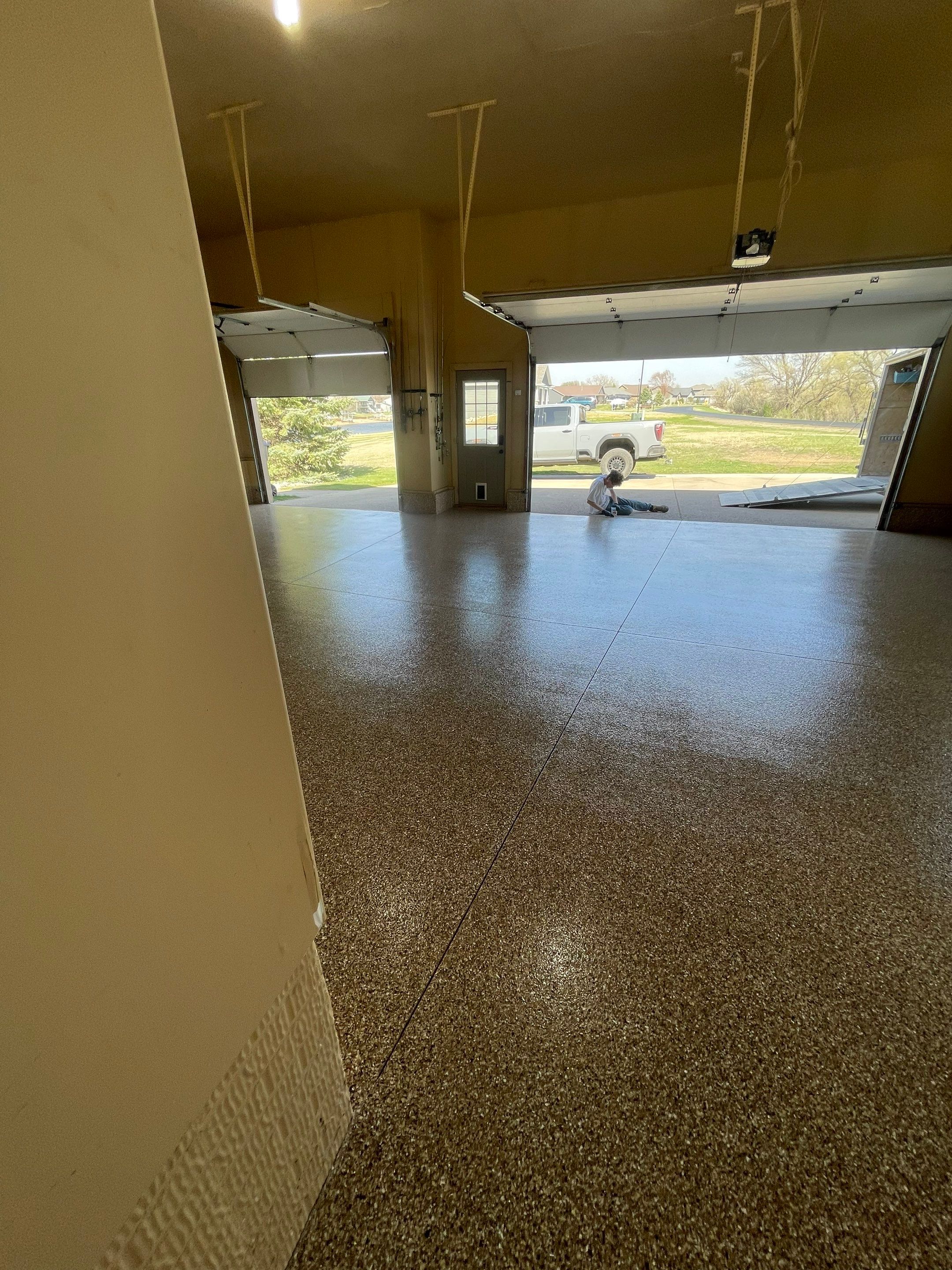 Residential Garage Floor Transformation with Speckled Epoxy Coating by Select Painting, Coatings & Garage Cabinets