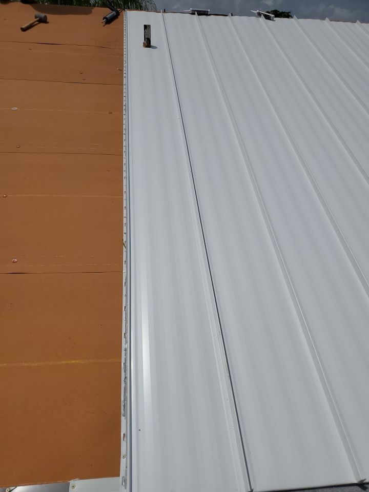 Residential Roofing Installation using 1.5" Nail Strip 24ga Solar White Kynar Coated Standing Seam Metal Panels by Morton Roofing, Inc.