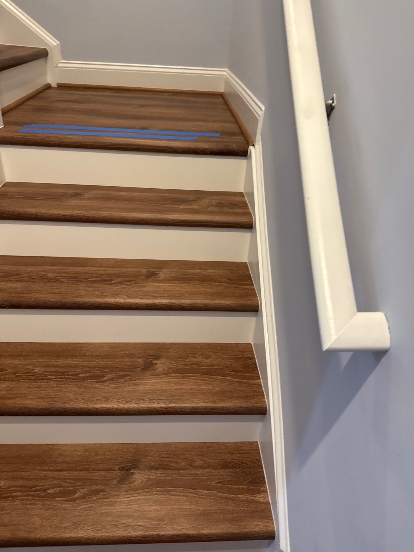 Stairway Installation using t vinyl stair tread and reversibleriser by La Bendicion Contruction Llc