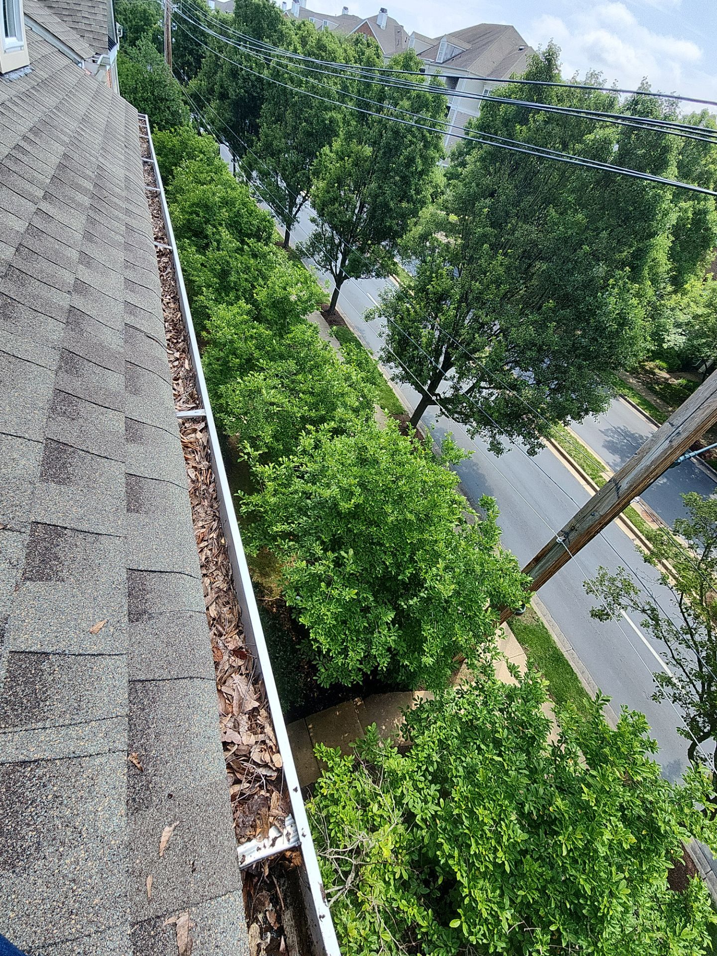HOA gutter cleaning in Winchester, VA,before  photo showing full gutters.