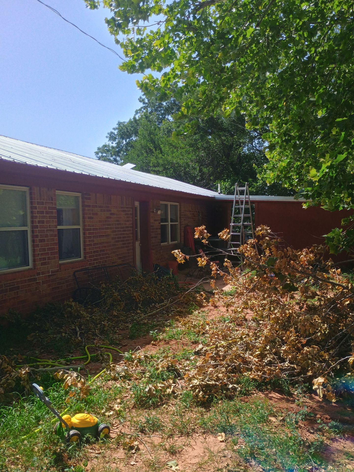 Corrugated Metal Roof Repair for Brick Home in Lindsay by BANA Roofing and Solar Supply
