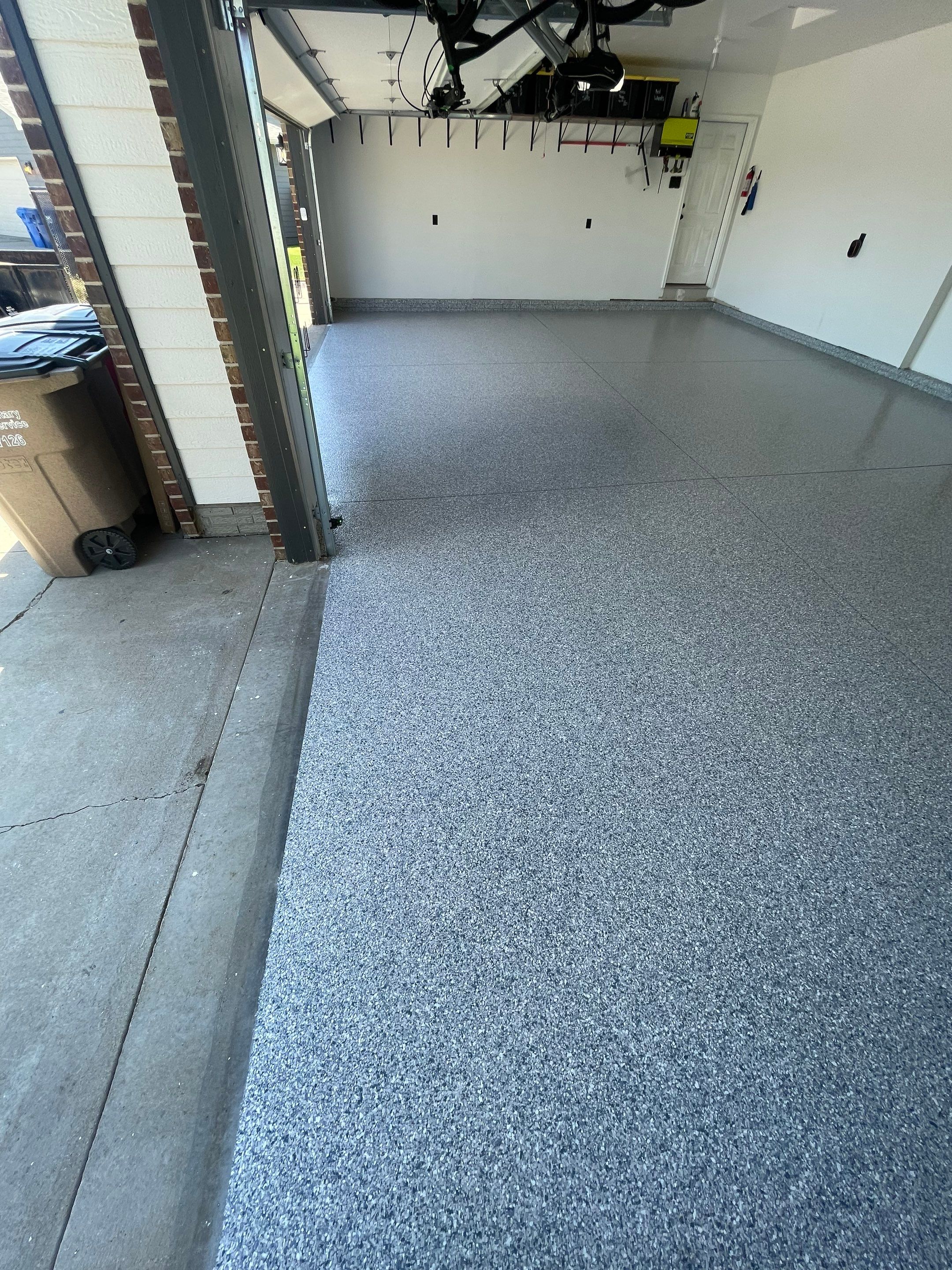 Tidal Wave Flake Garage Floor Installation in Sioux Falls by Select Painting, Coatings & Garage Cabinets