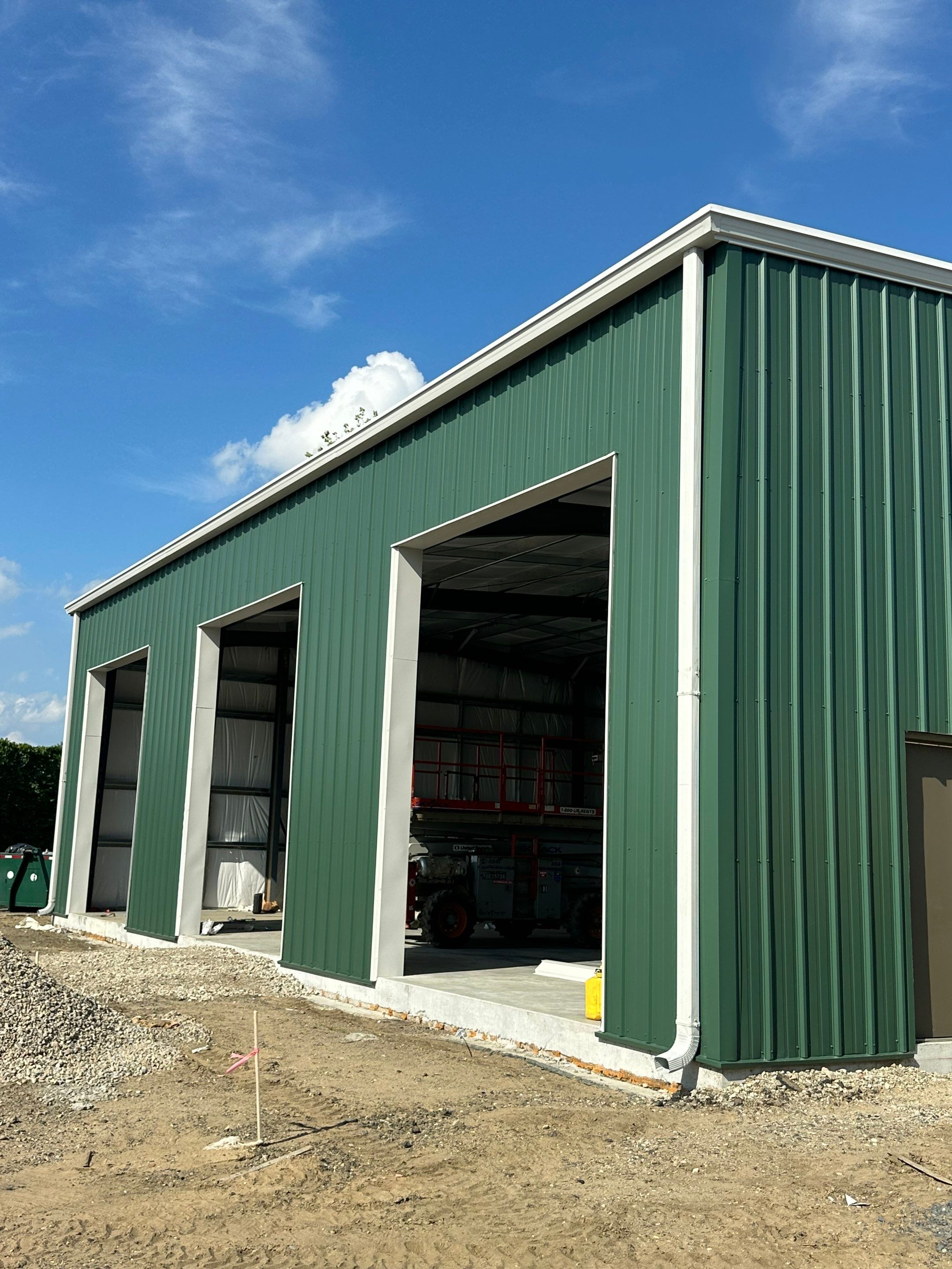 Dark Green Metal Siding by Reimagine Roofing