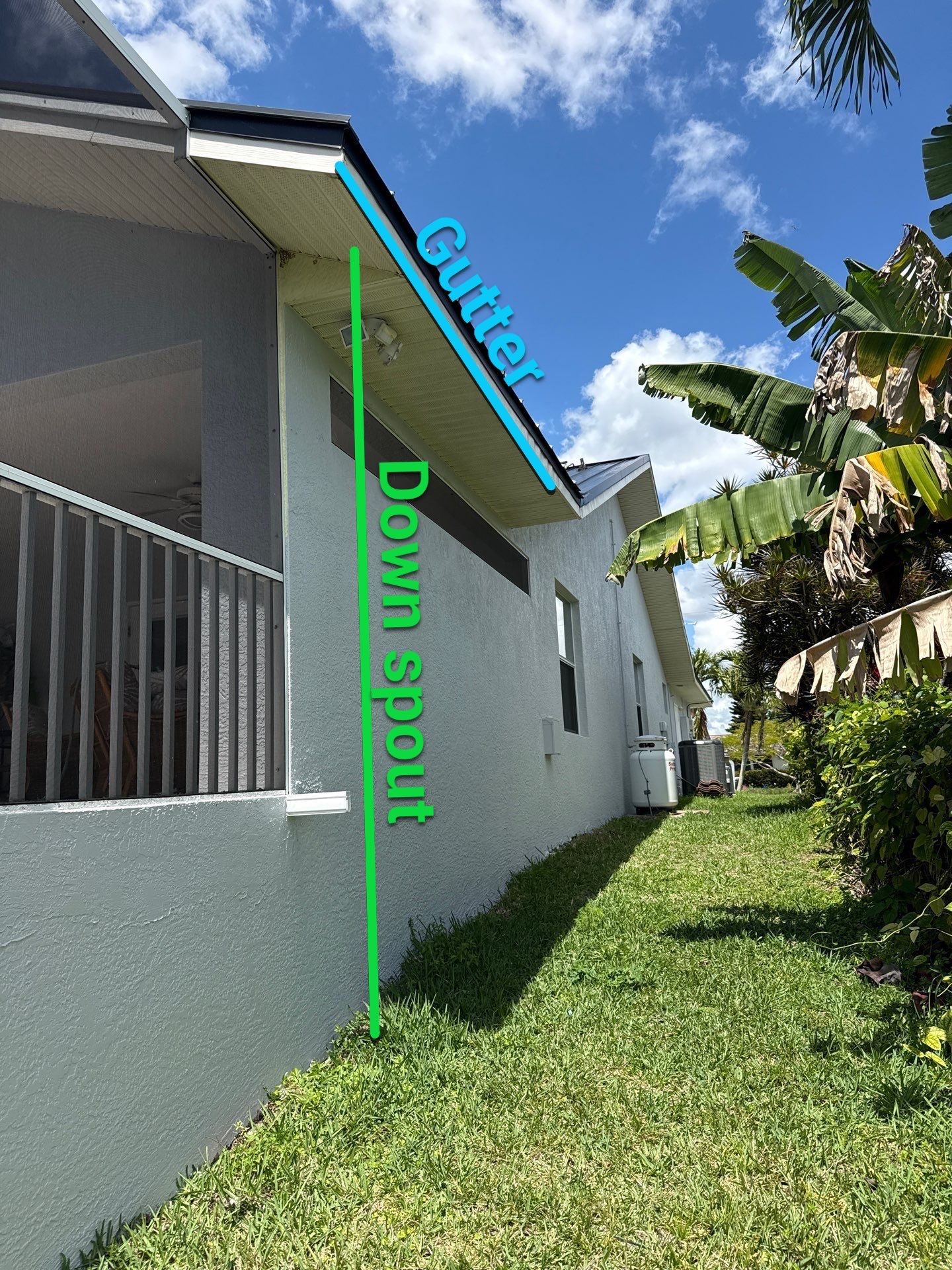 Black Seamless Gutters and White Downspouts in Cape Coral FL by Gutter Professors