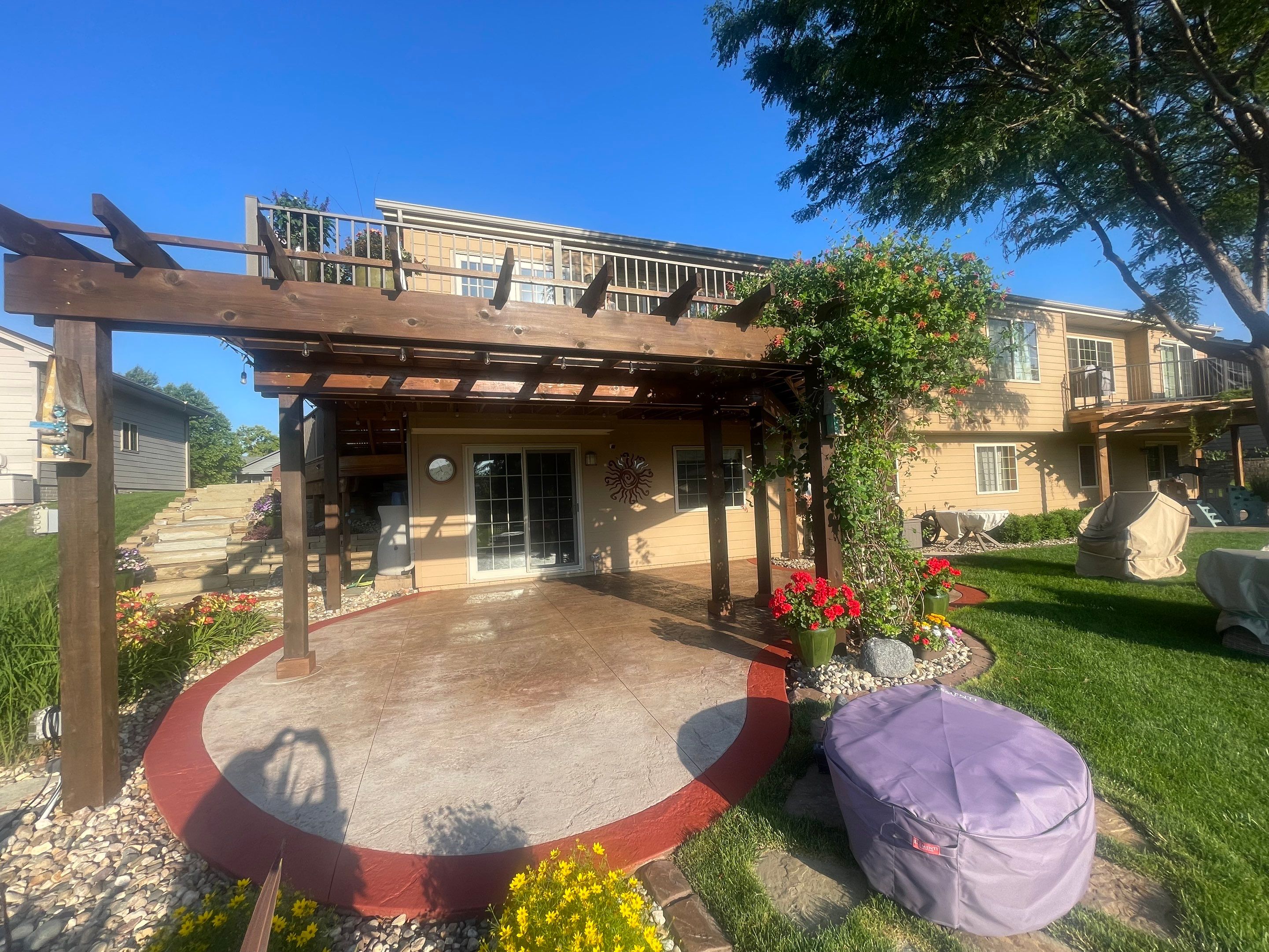 Custom Stamped Concrete Patio and Wood Pergola in Sioux Falls by Select Painting, Coatings & Garage Cabinets