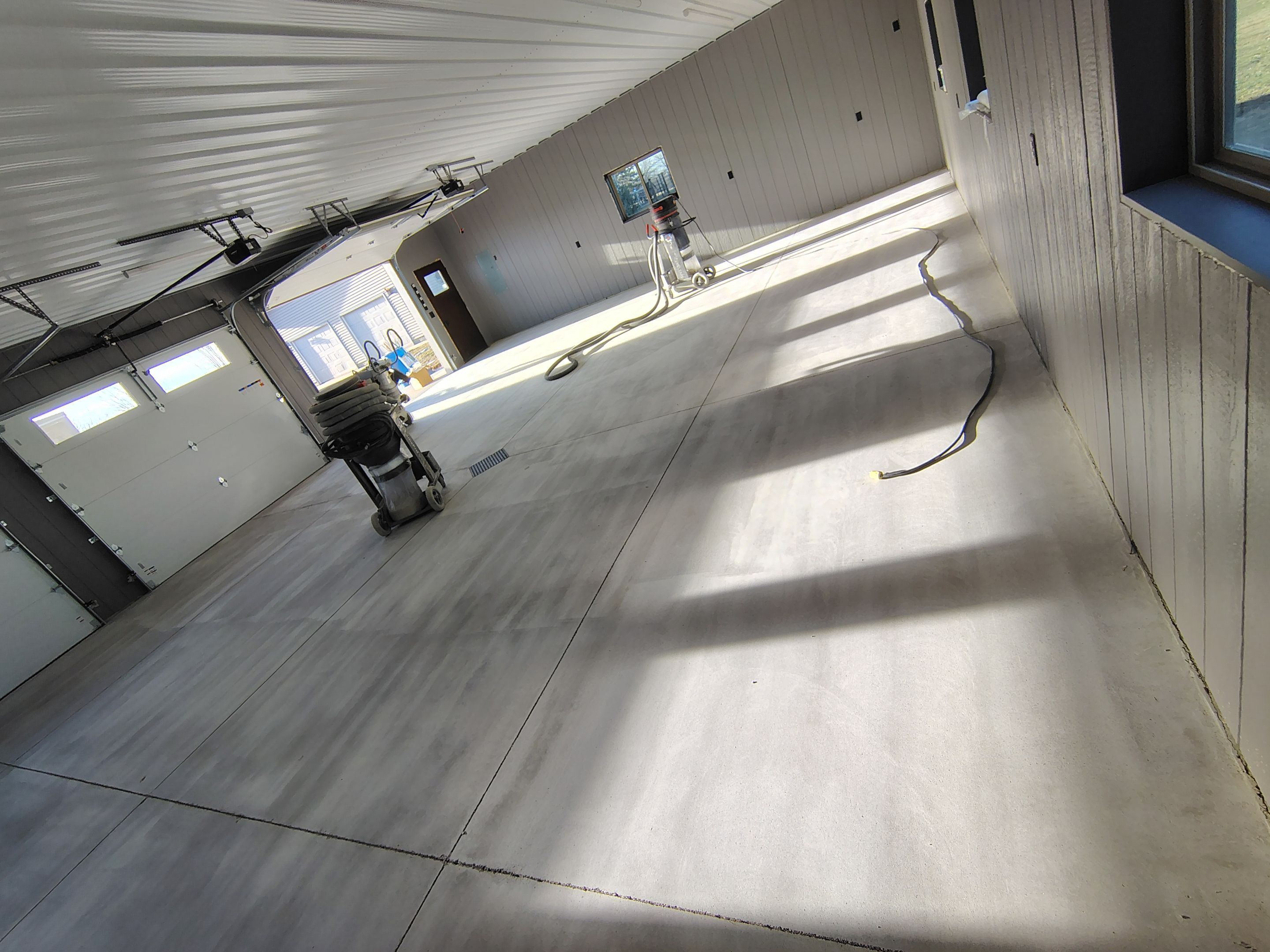 Speckled Epoxy Floor Coating for Large Shop in Rock Valley by Select Painting, Coatings & Garage Cabinets