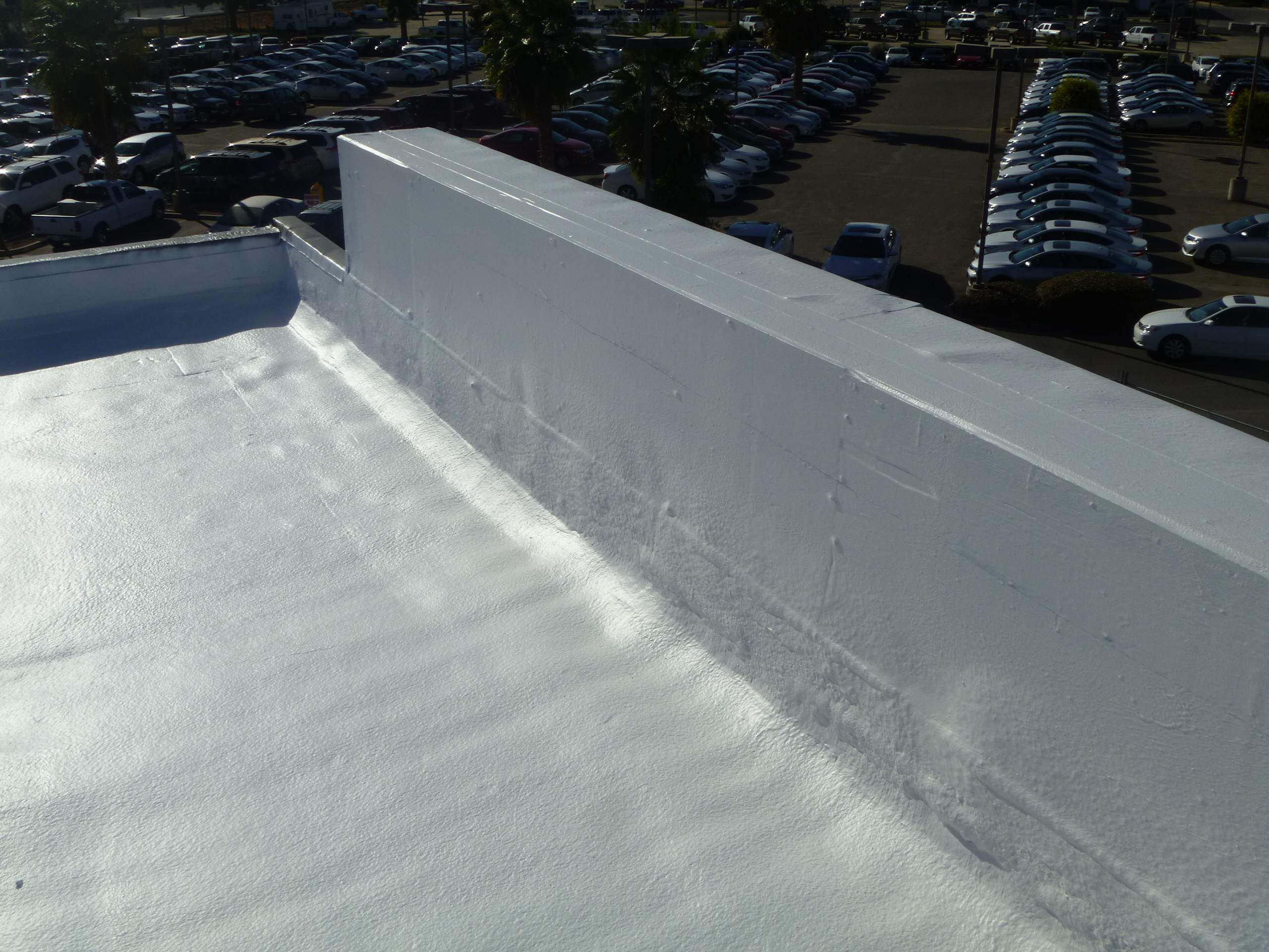 Commercial Roofing Installation using Spray foam and Conklin Benchmark/PUMA XL 18 yr warranty coatings by Straight Edge Roofing Inc