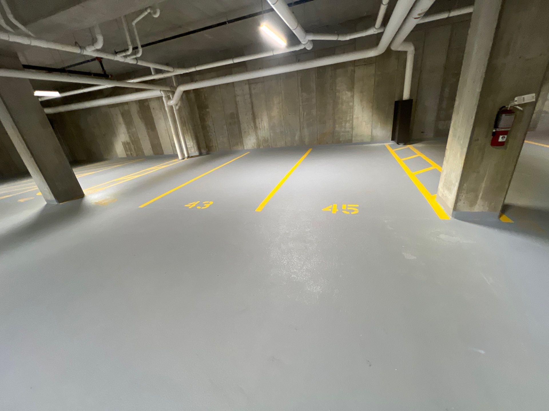 Parking garage using Hot water by Northern Power Washing LLC.