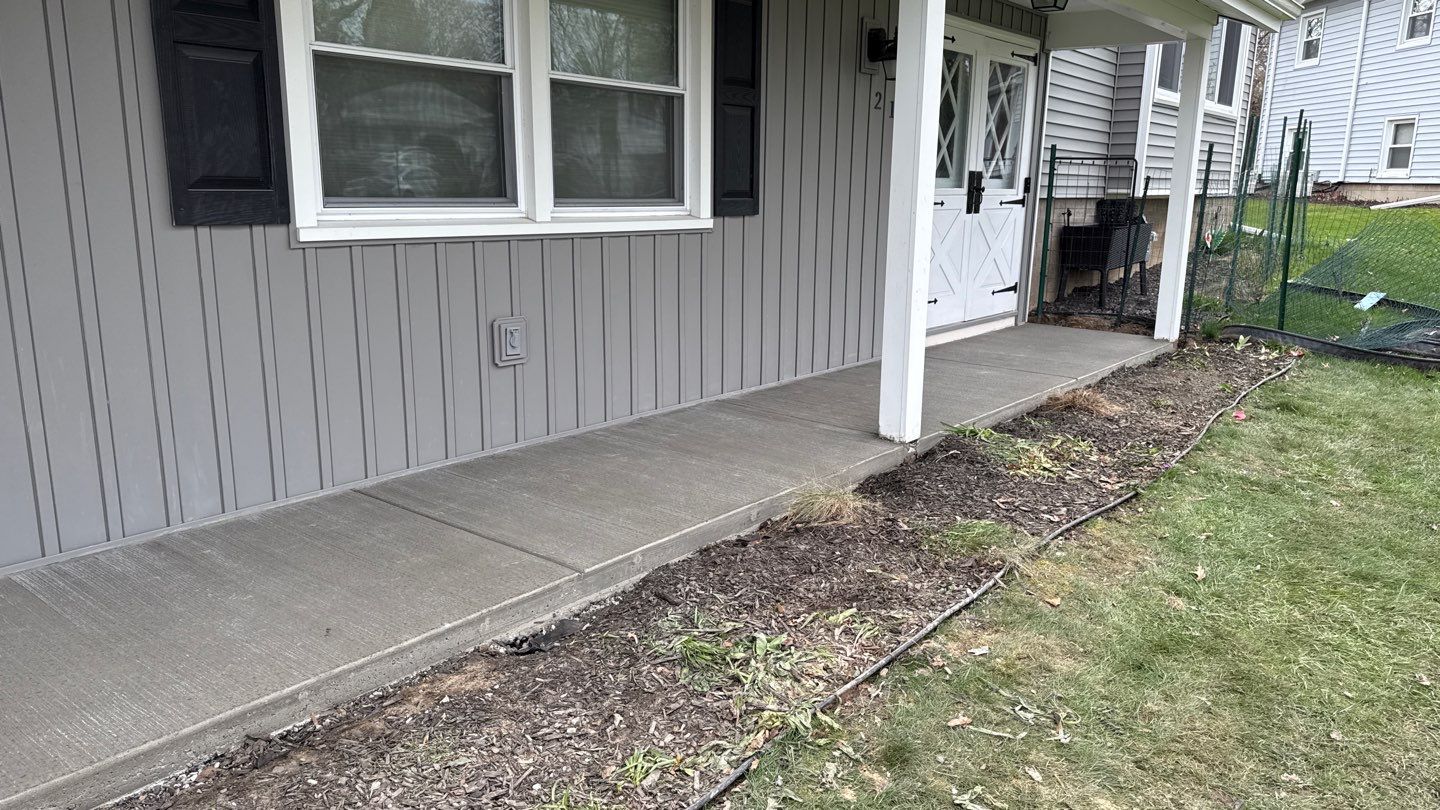 Concrete garage floor replacement with a broom finished apron and sidewalk  by NG Masonry & Construction LLC