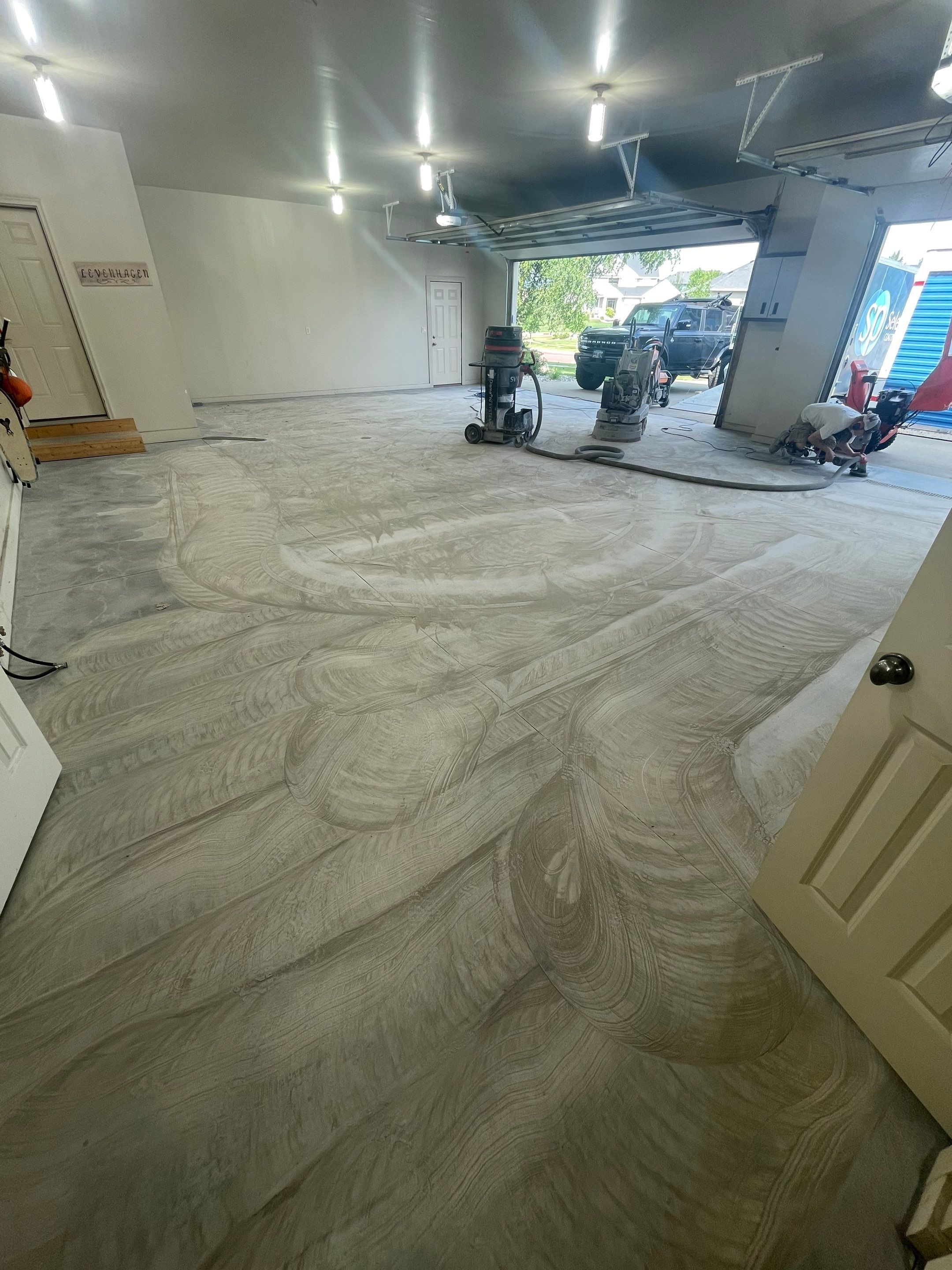 Coyote Flake Garage Floor Coating in Sioux Falls with Trench Drain by Select Painting, Coatings & Garage Cabinets