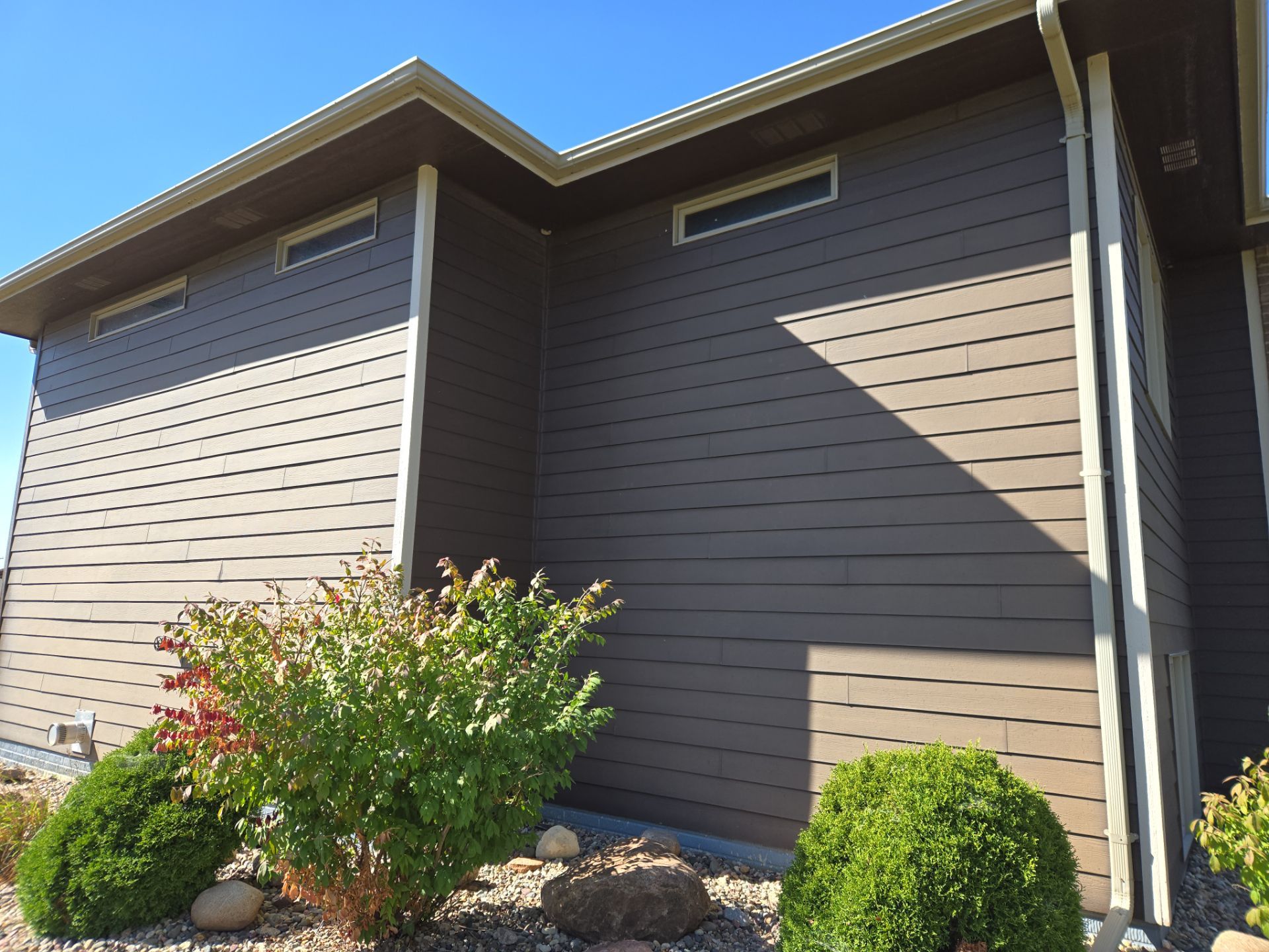 Dark Blue Exterior Home Painting and Siding Refresh in Sioux Falls by Select Painting, Coatings & Garage Cabinets