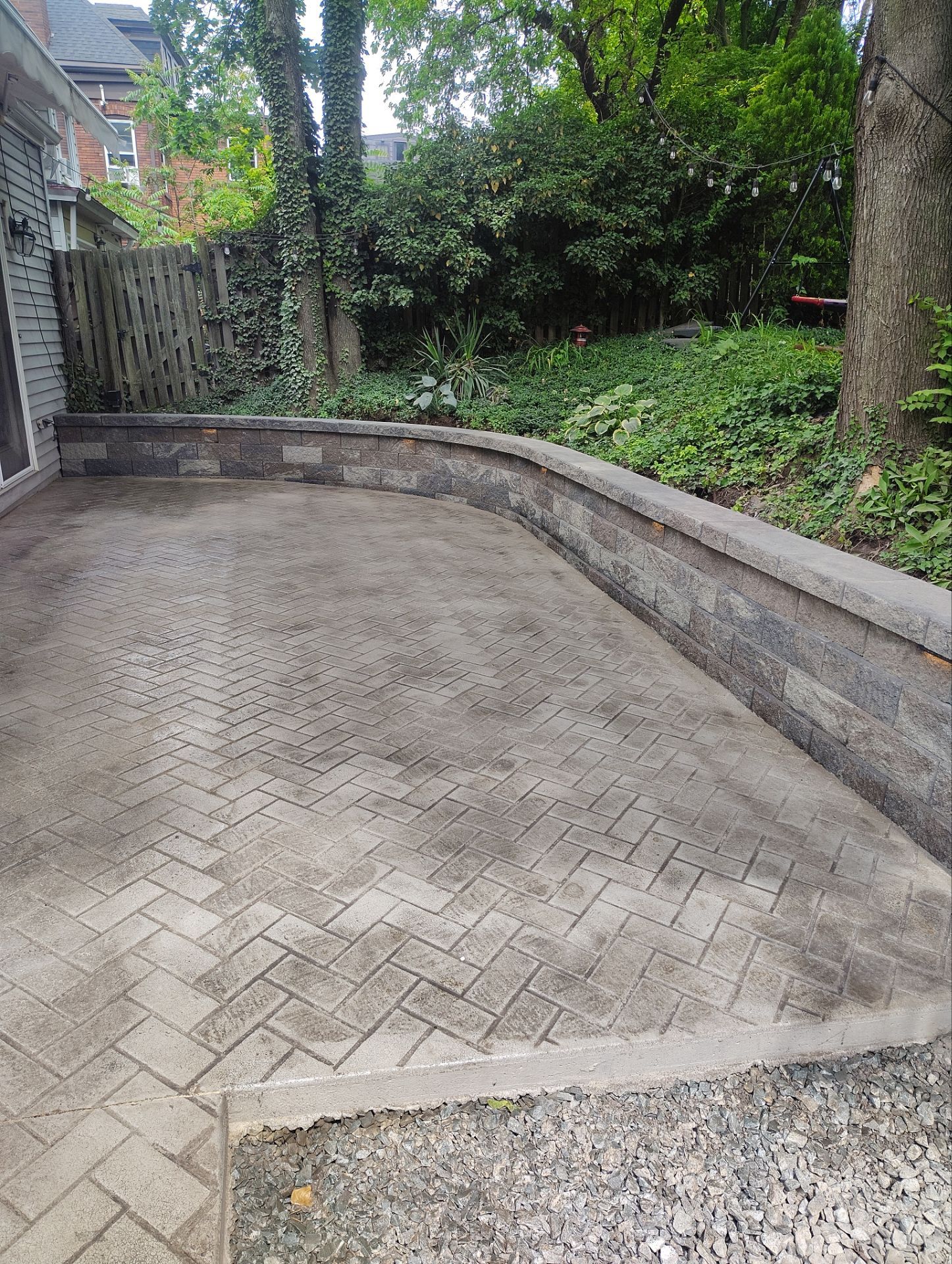 Stamped Concrete and Retaining Wall by Cousins Roofing Siding & Decks