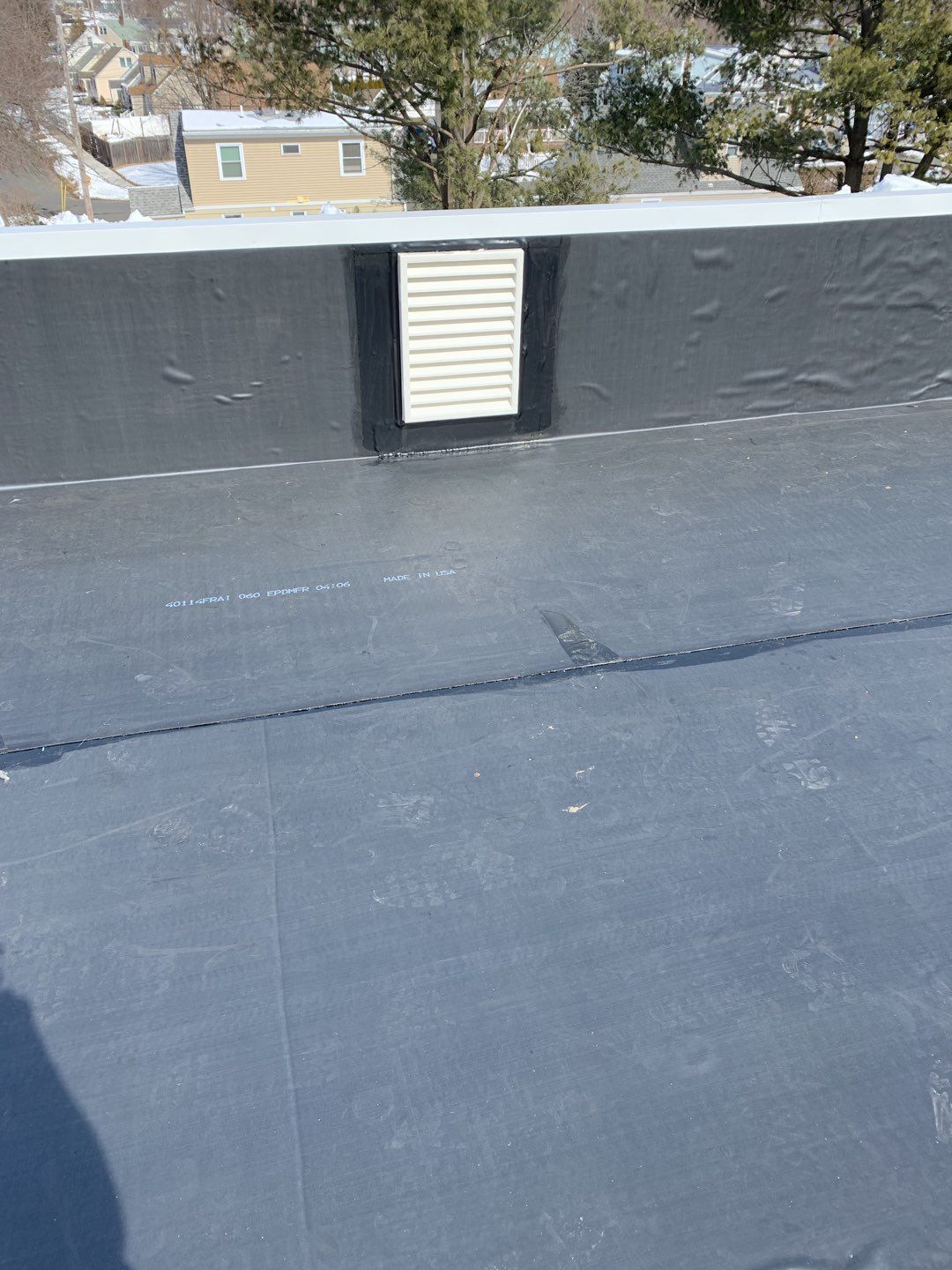 Commercial Roofing Installation using EPDM with white gutters by A Plus Exterior