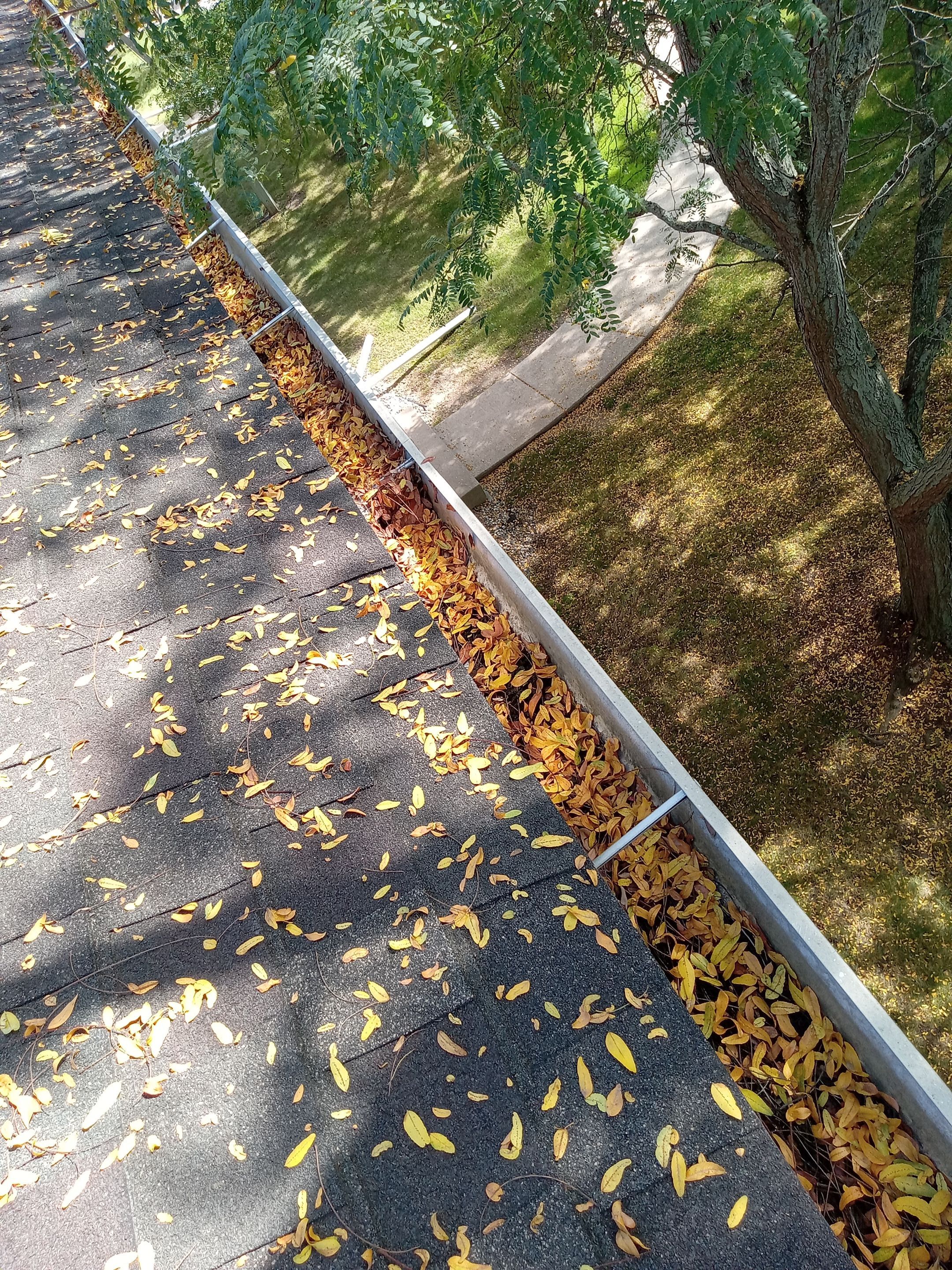 Commercial gutter cleaning Lansing before photo with filled gutters